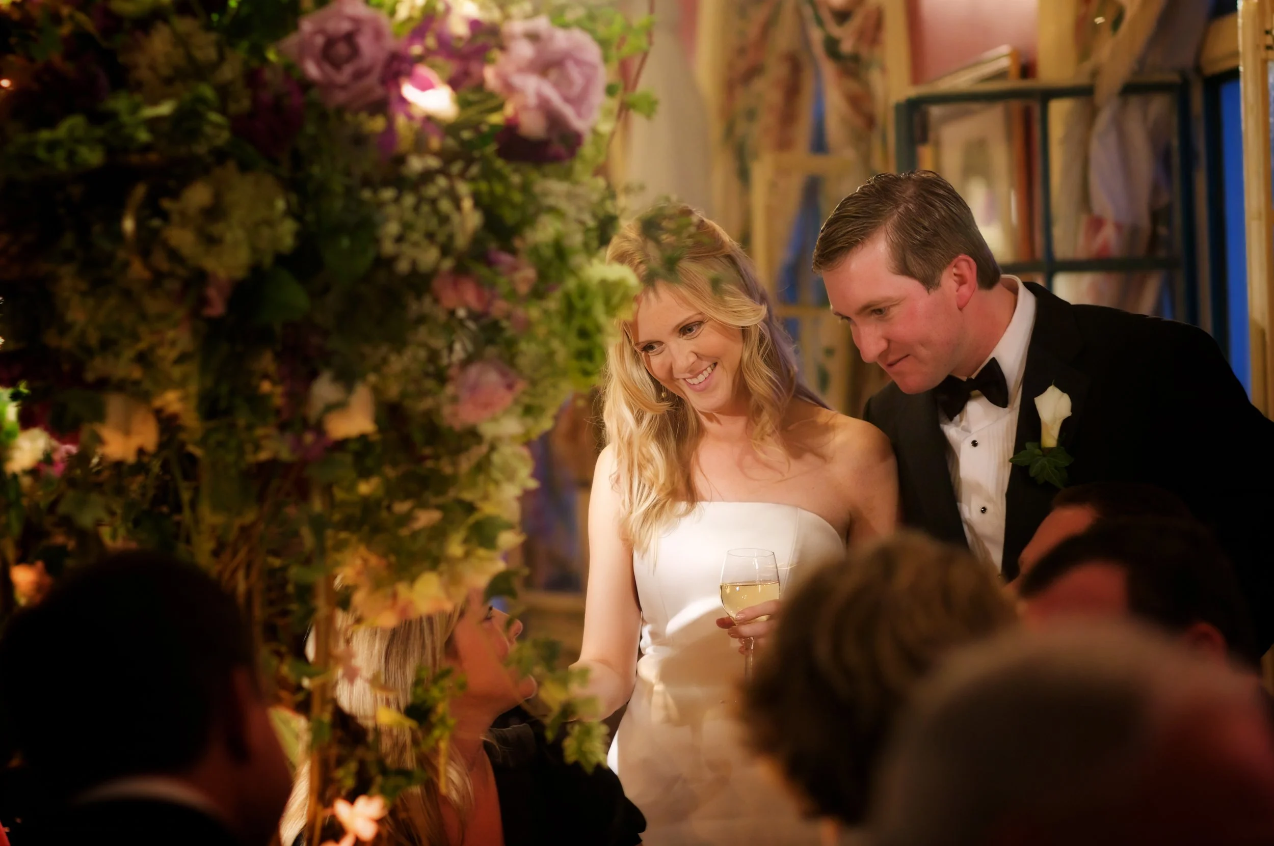 Bride and groom greet guests at their tables during a wedding reception at Siwanoy Country Club.