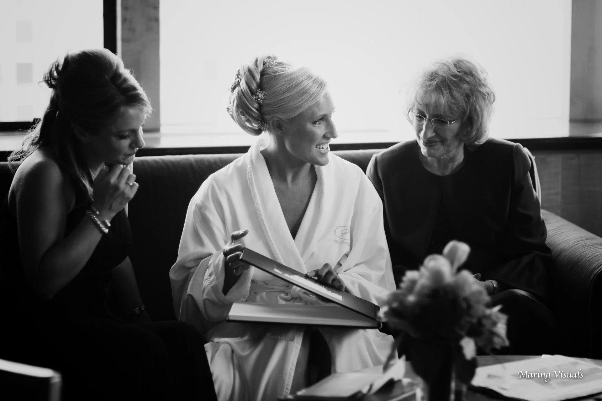 The bride looks through her engagement portrait book