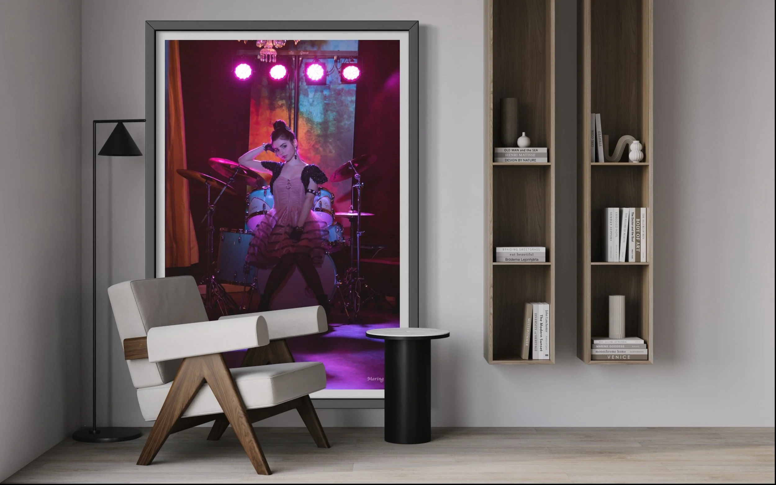 Portrait of a young woman seated at a drum set under colorful concert lighting by Maring Visuals