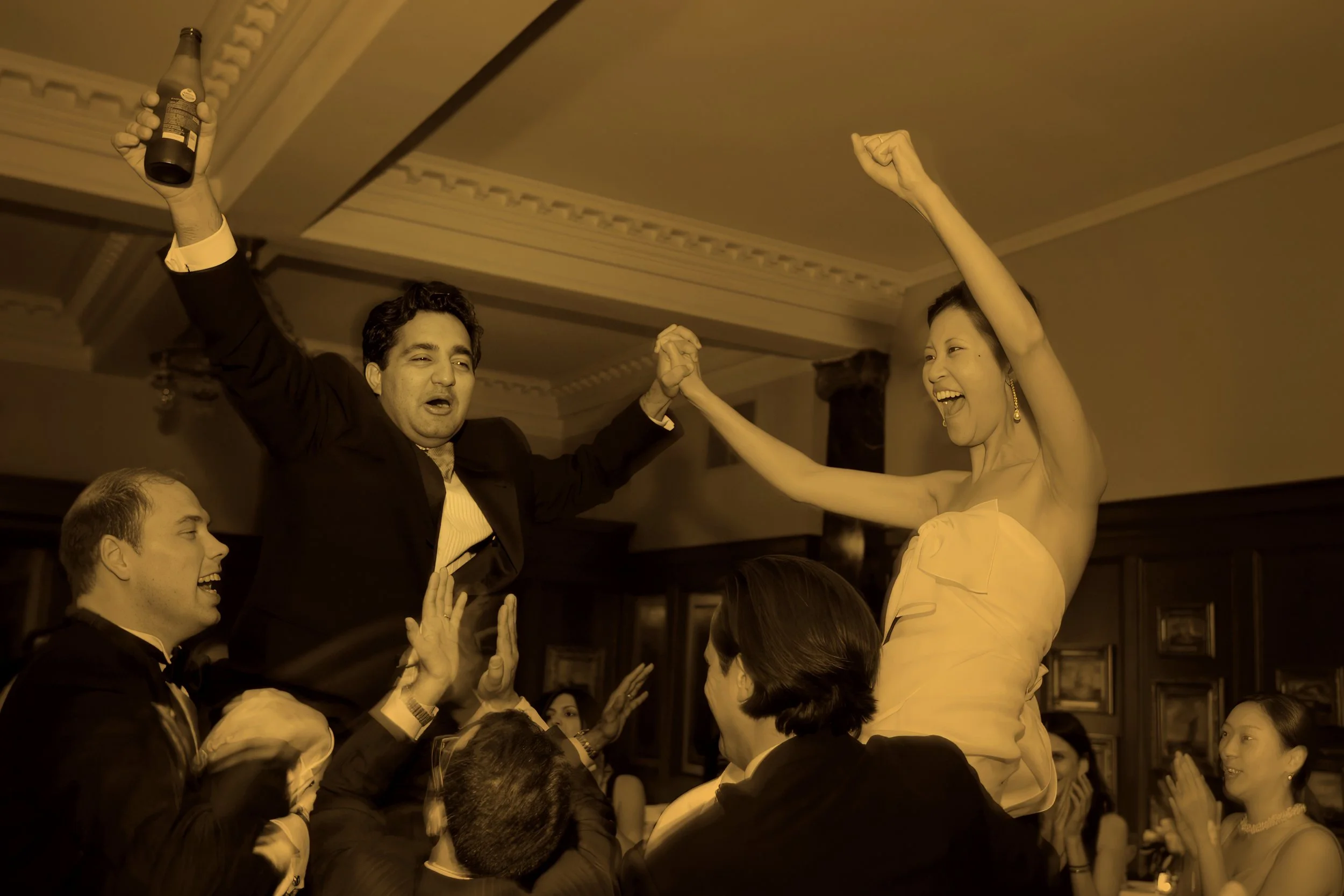 Bride and groom lifted up during their wedding reception at Union League Cafe