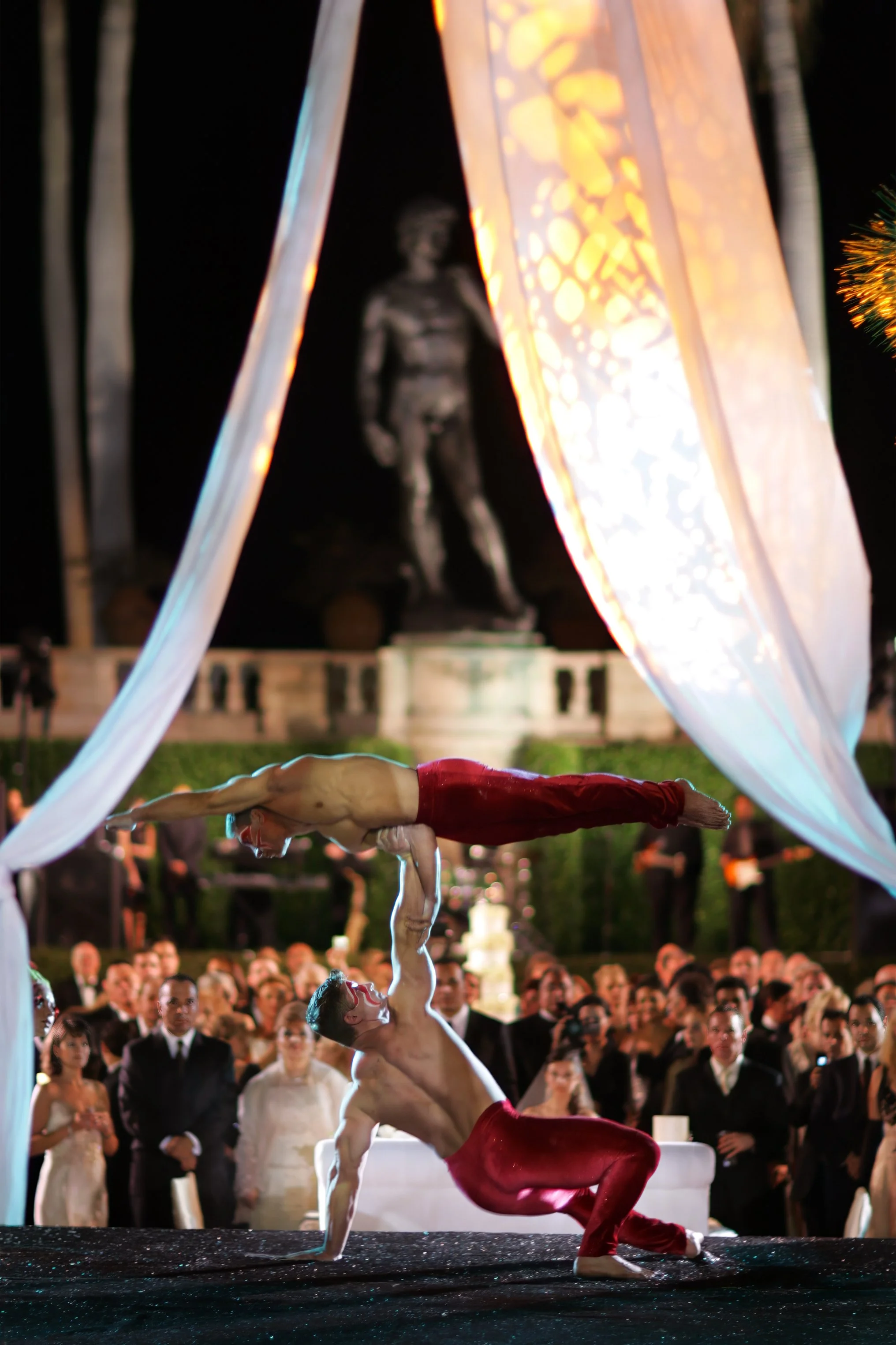 Acrobatic wedding entertainment performing during a reception in the courtyard at the Ringling Museum Sarasota