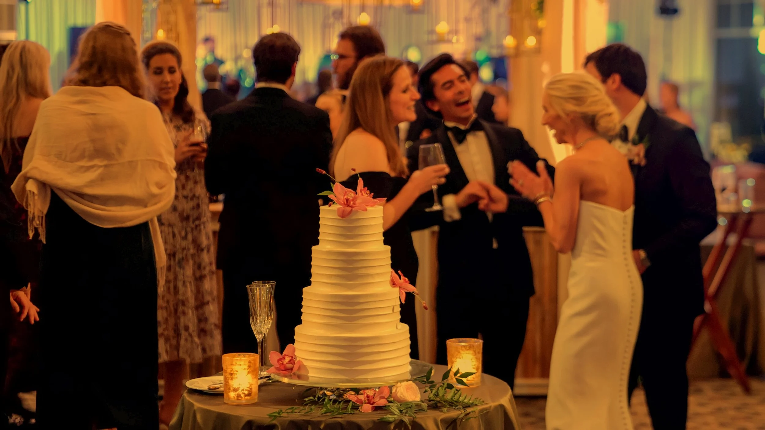 Bride and groom mingle with guests during a luxurious ballroom reception at Pinehurst Resort.
