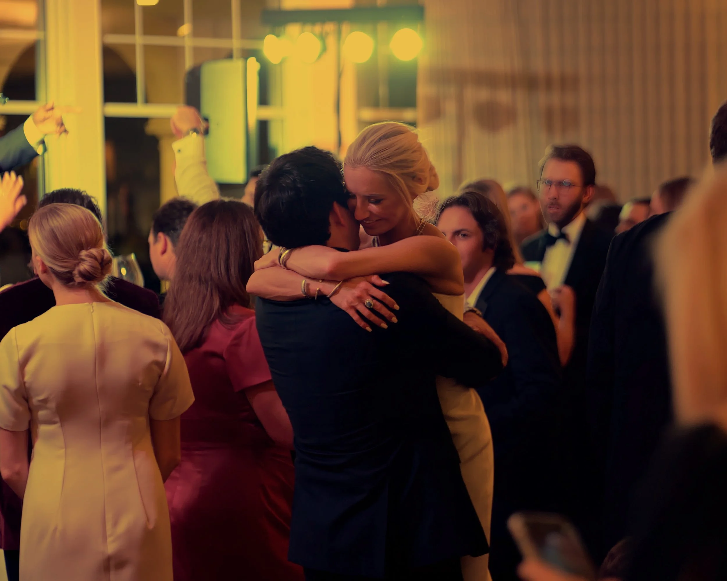Bride and groom share a loving embrace on the dance floor in a Pinehurst Resort ballroom.
