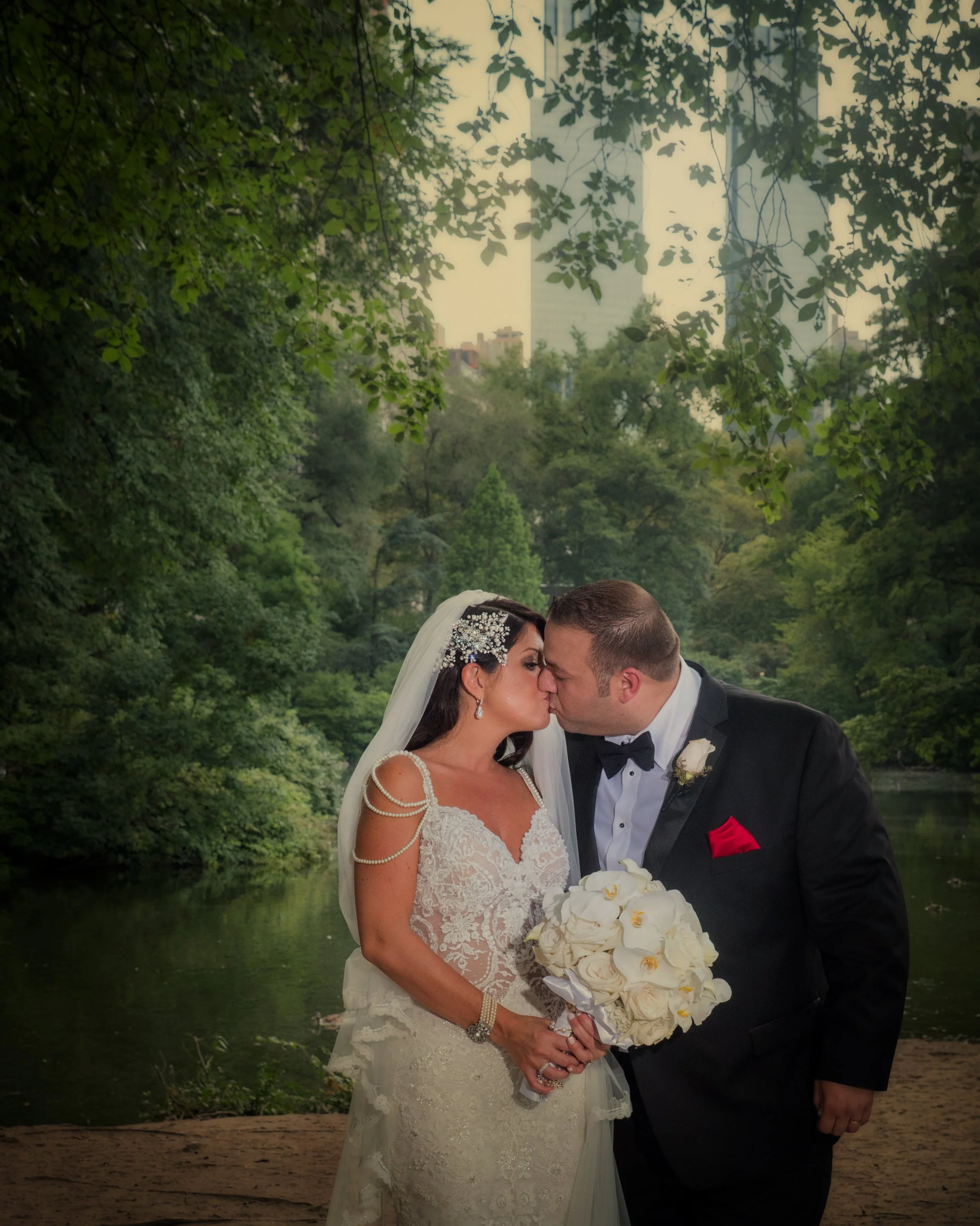 Bride and Groom Kiss by Central Park Pond