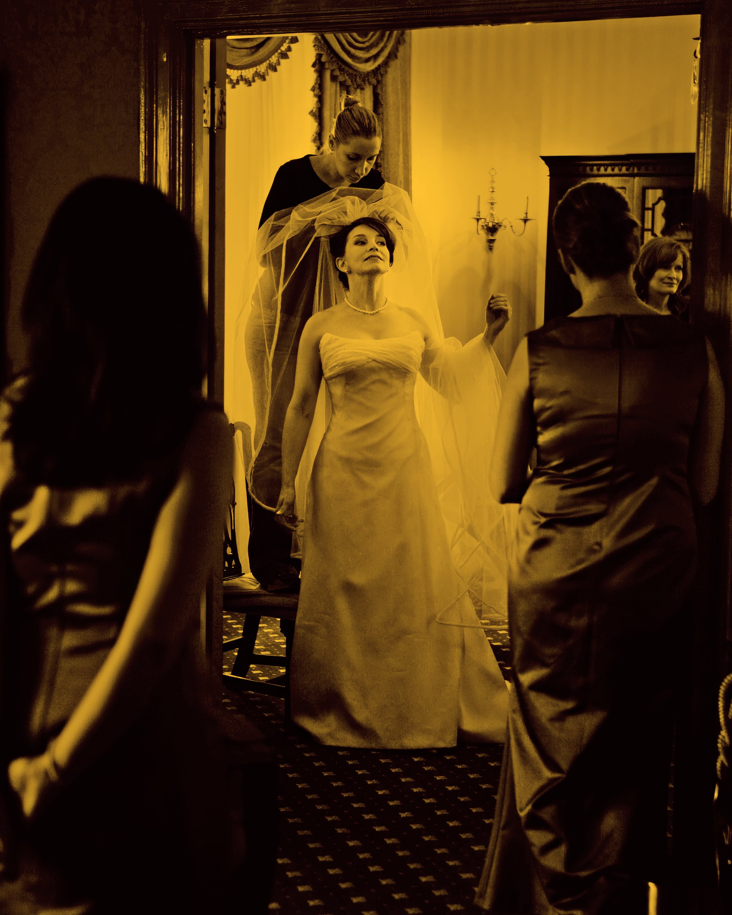 Bride Prepares with Veil Assistance in Luxury Suite