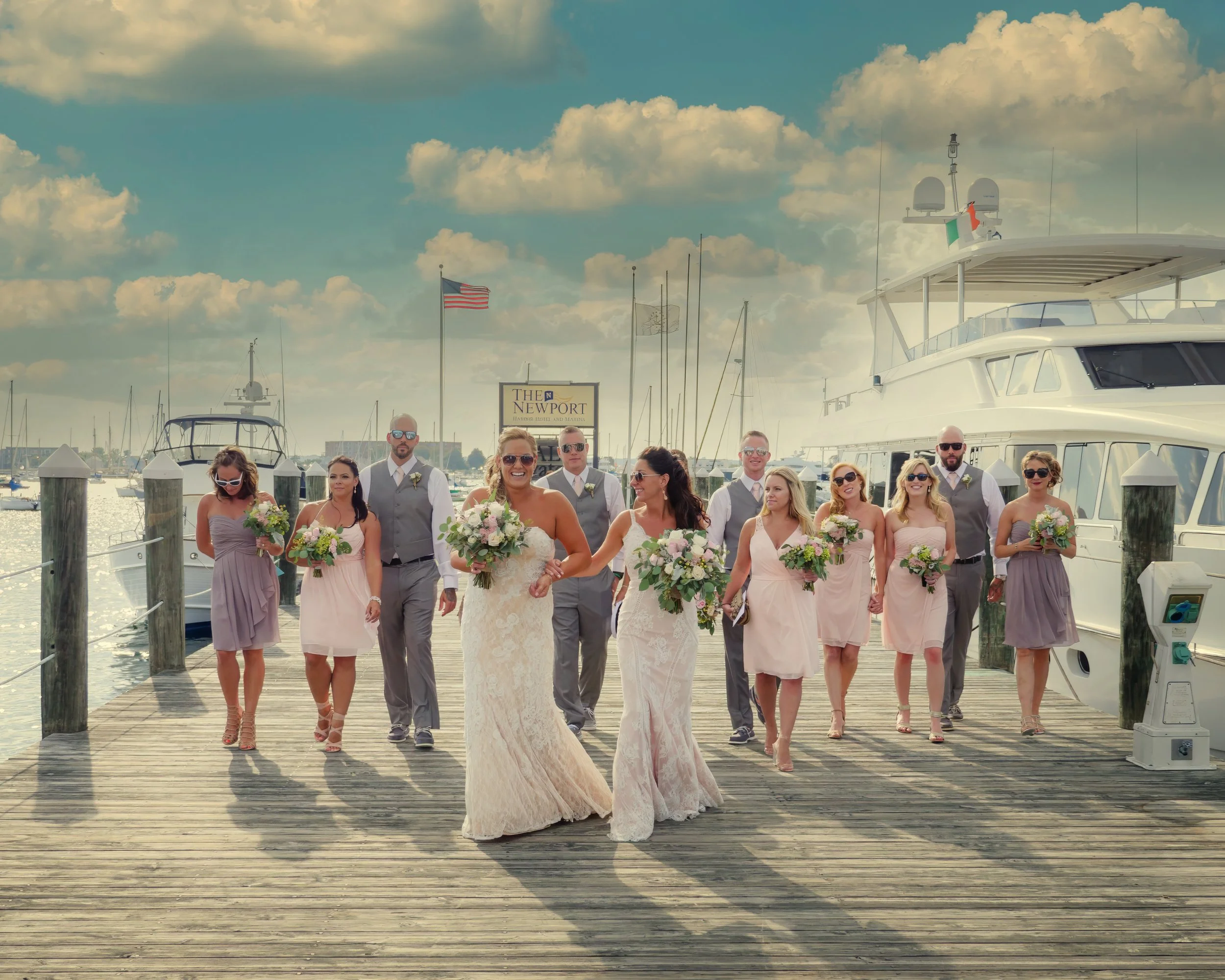 Wedding party walking on the docks at The Bohlin with sweeping harbor views.
