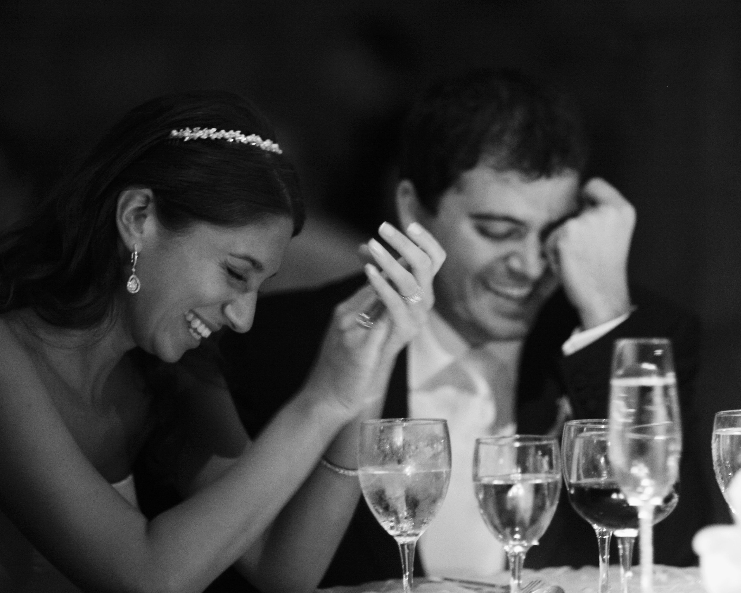 Bride and groom laugh and smile as they listen to wedding toasts during their reception at Tappan Hill.