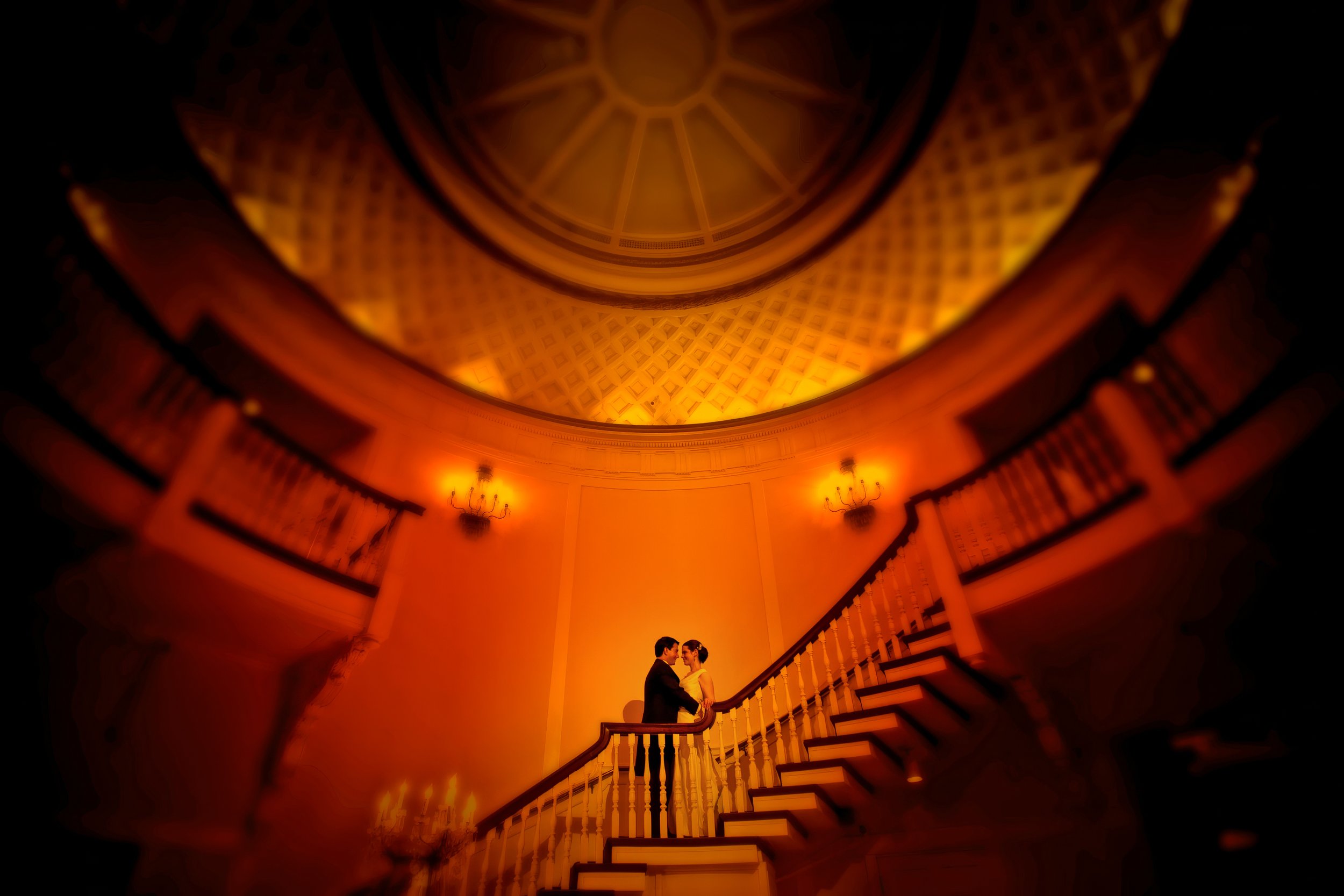 Bride and groom share a romantic moment on the grand staircase in the Rotunda foyer at Tappan Hill Mansion in Westchester.