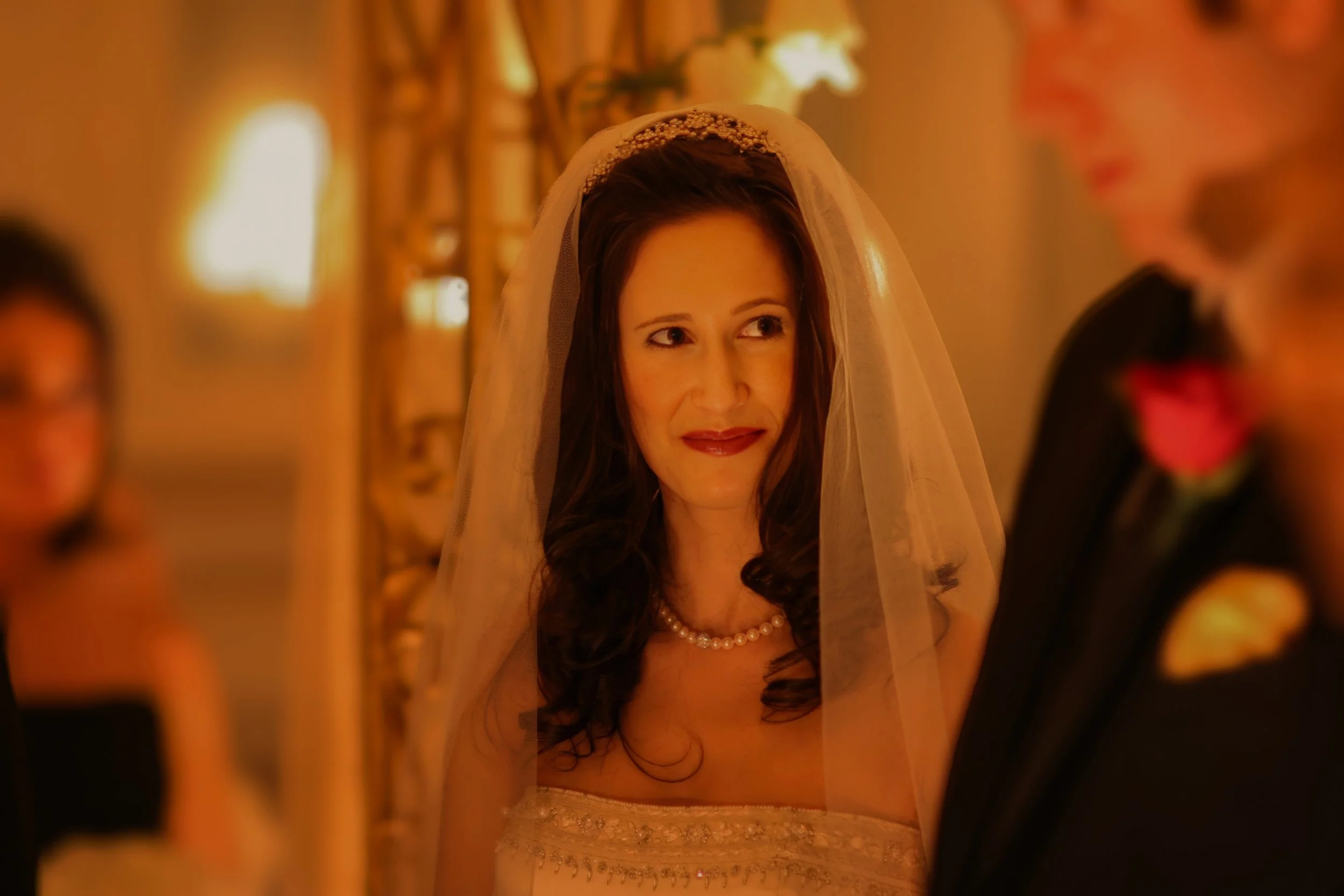 Bride’s Loving Glance During Candlelight Ceremony