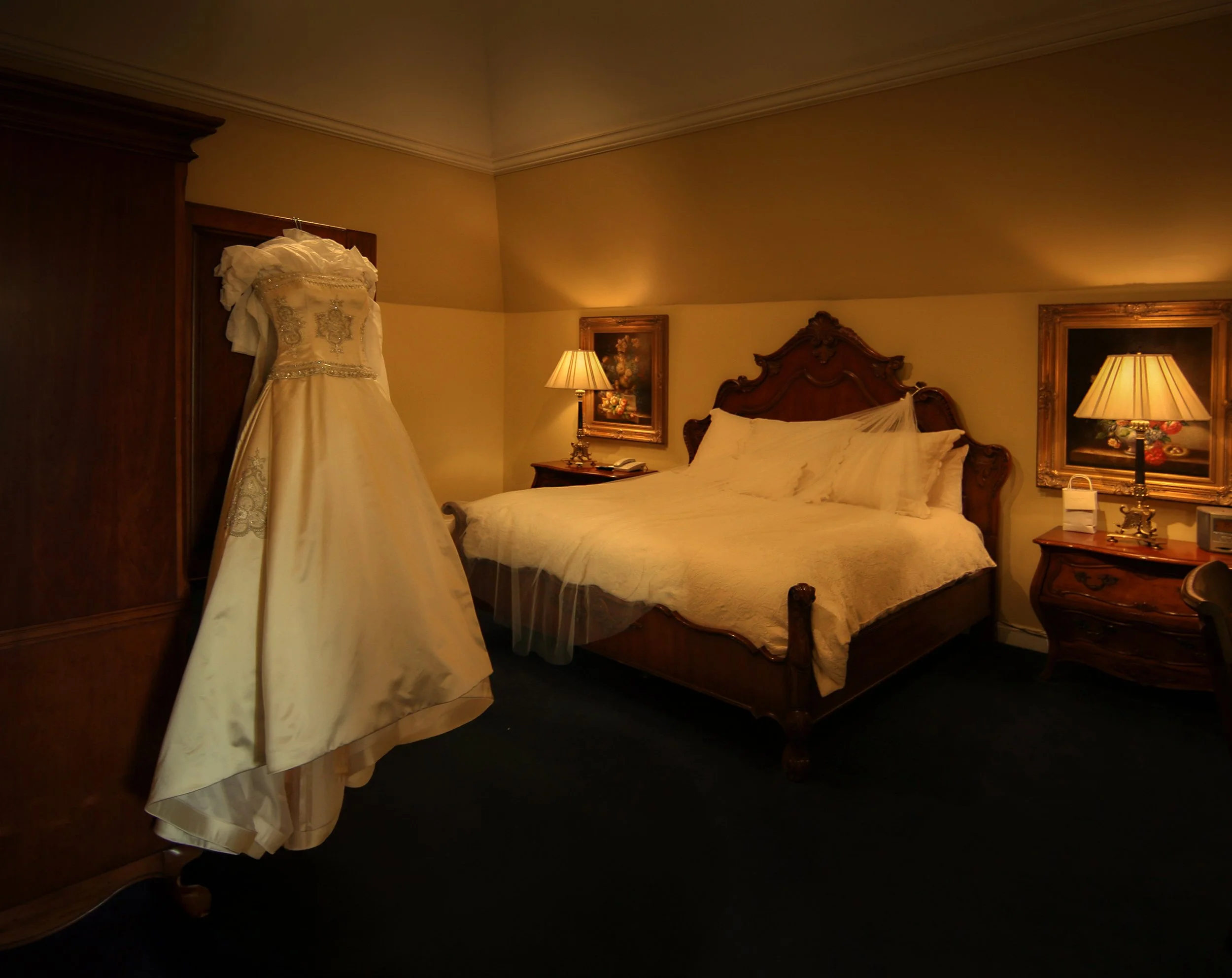 Wedding gown hanging in the bridal suite at Oheka Castle before a Long Island castle wedding