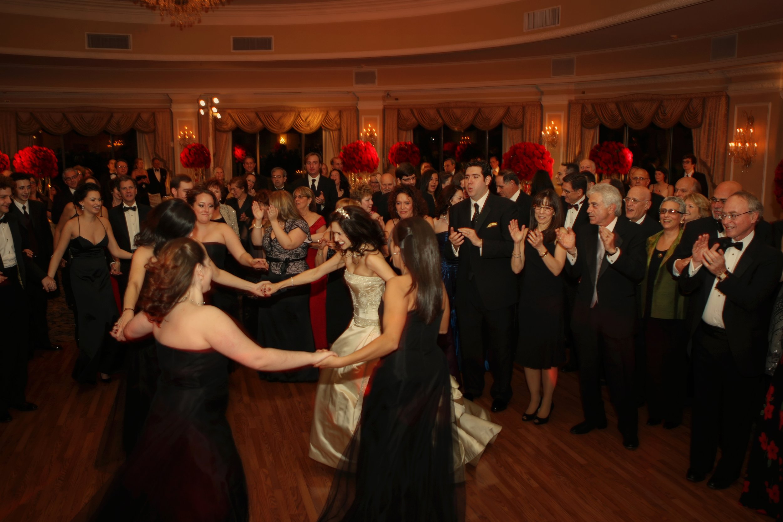 Bride dancing with friends during the Hora in the ballroom at an Oheka Castle wedding reception