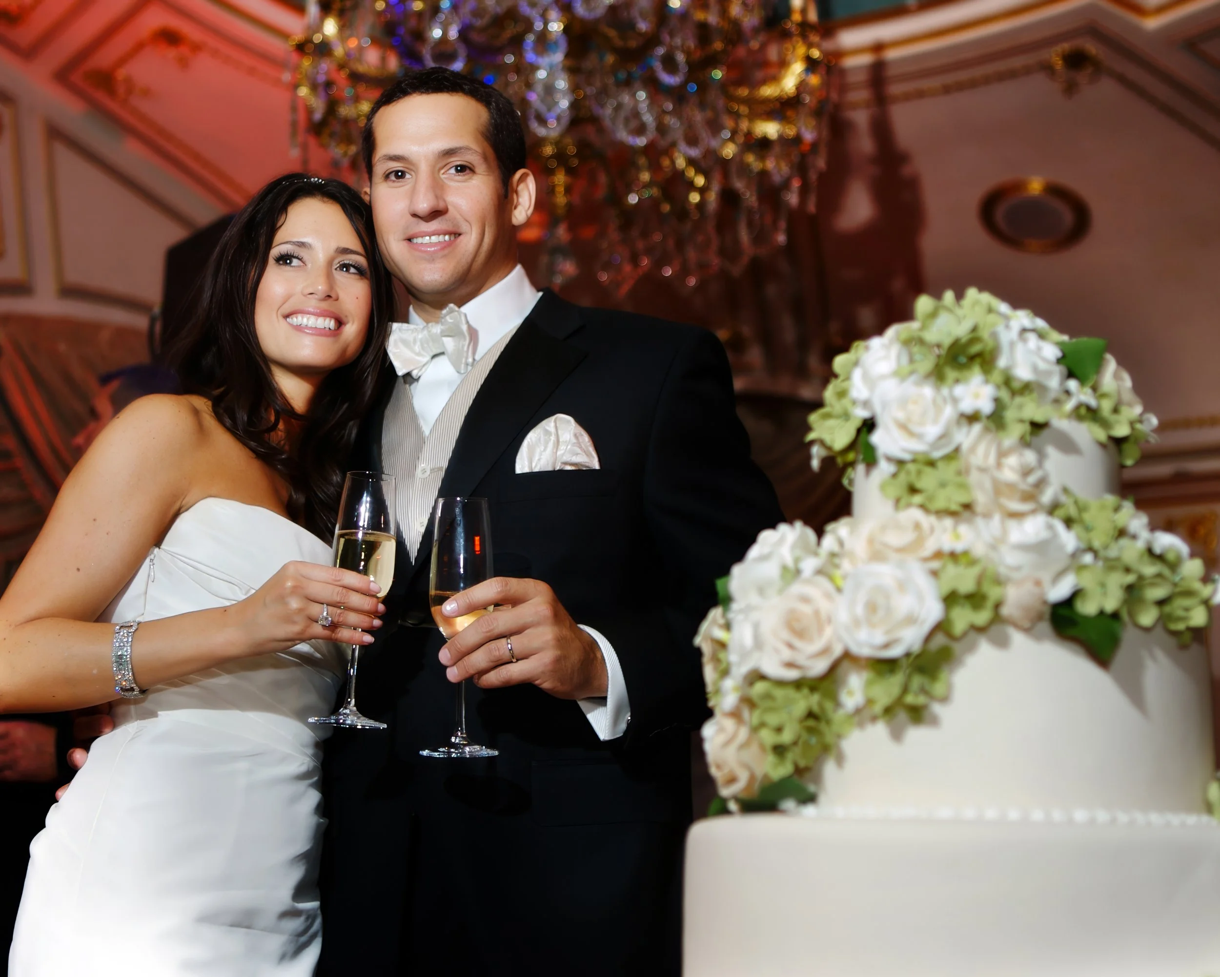 Bride and groom sharing a candid moment after their cake cutting in the ballroom at The St. Regis New York.