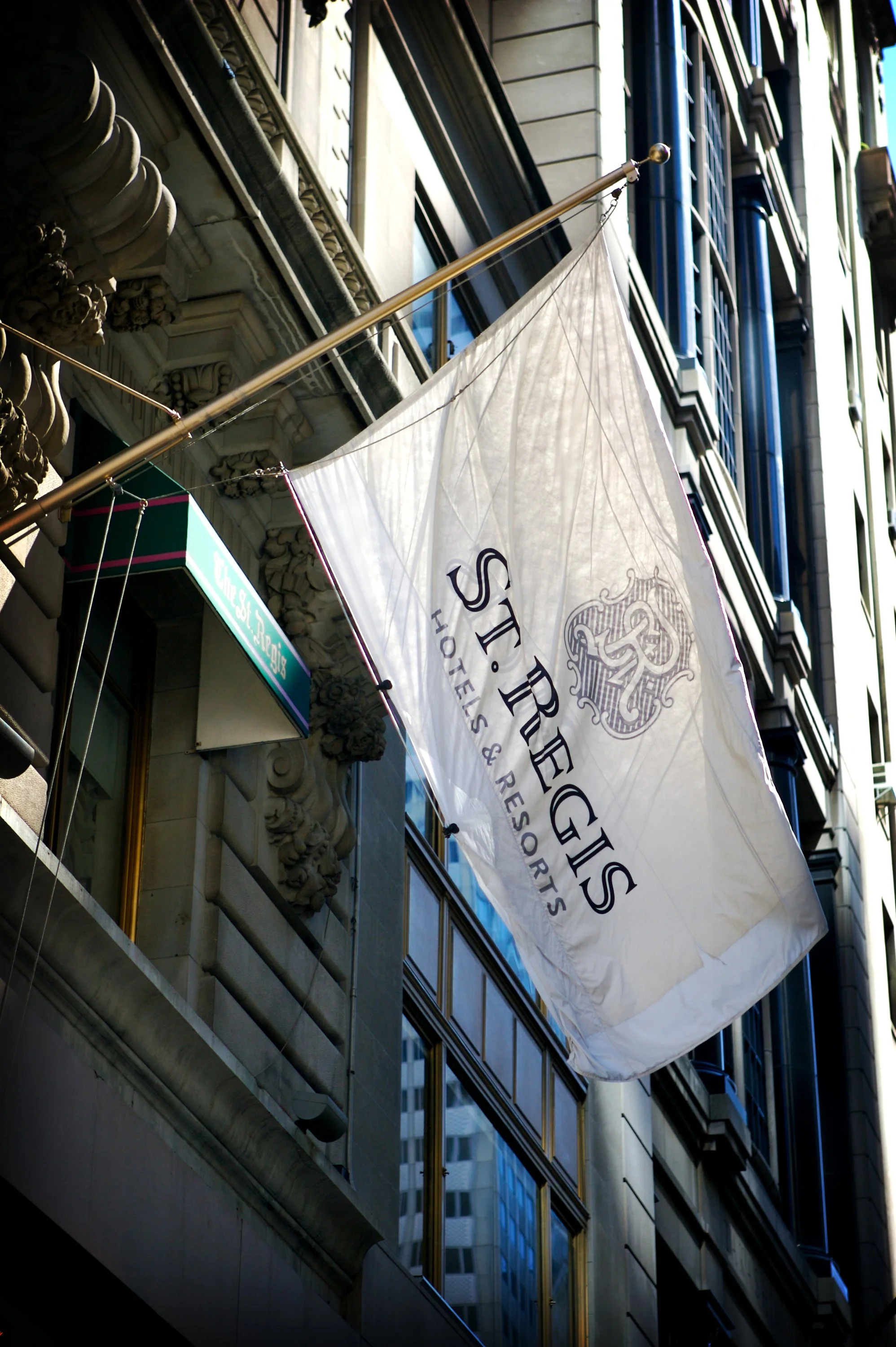 Flag flying at the Fifth Avenue entrance of The St. Regis New York, a historic Manhattan wedding venue.