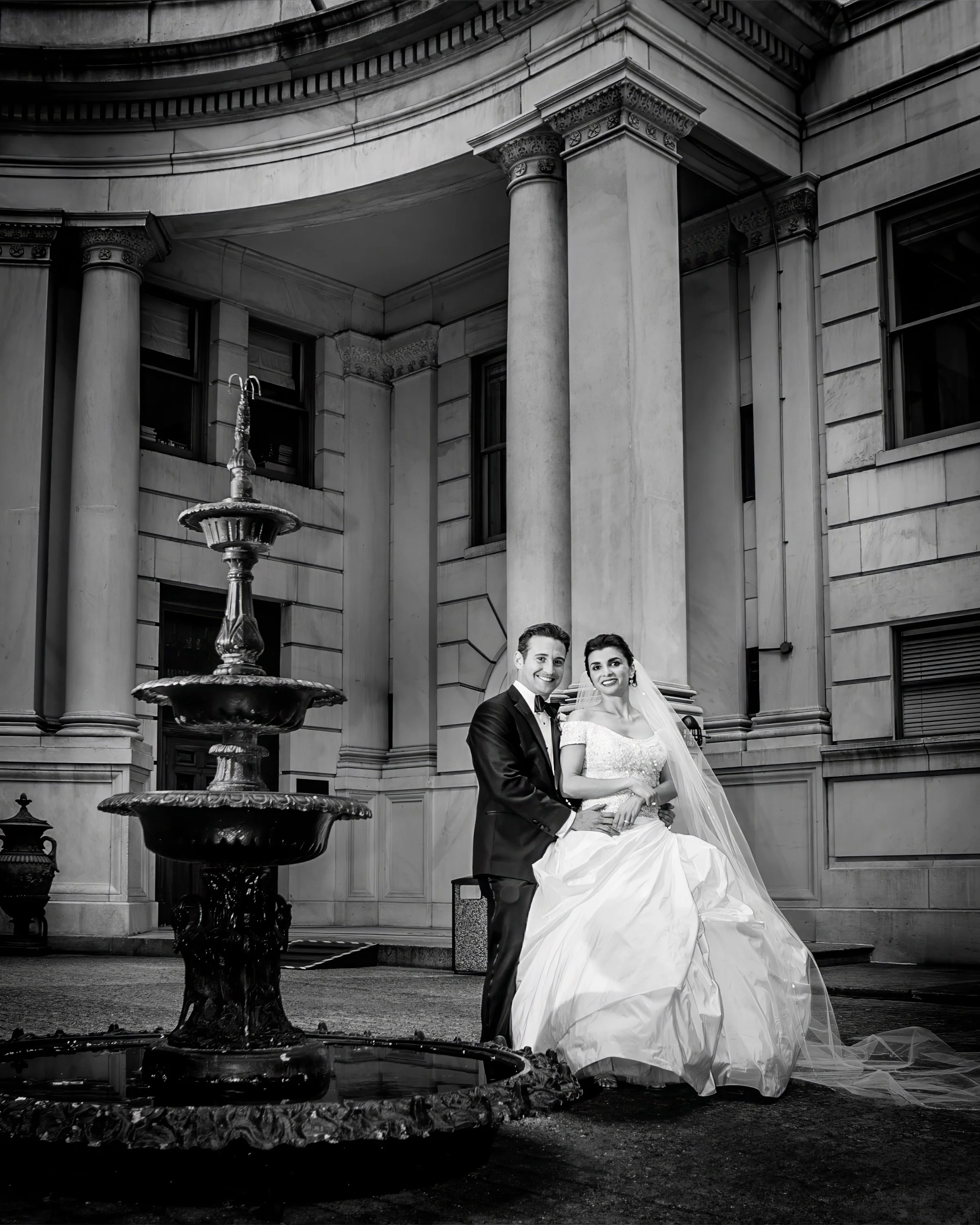 Black and white wedding portrait of bride and groom in the courtyard at the Metropolitan Club NYC