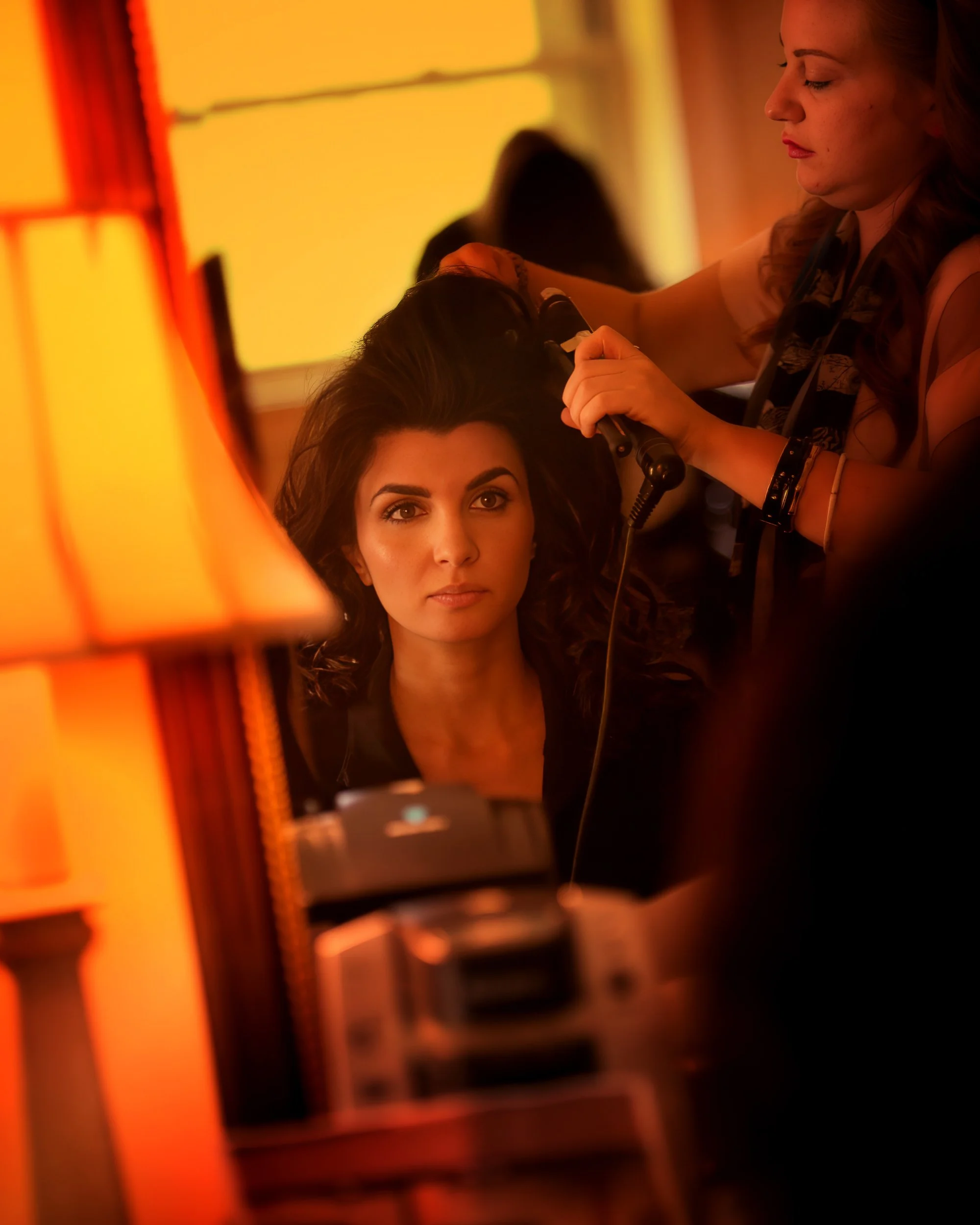 Bride getting ready with her hairstylist in a luxury bridal suite at the Metropolitan Club NYC wedding