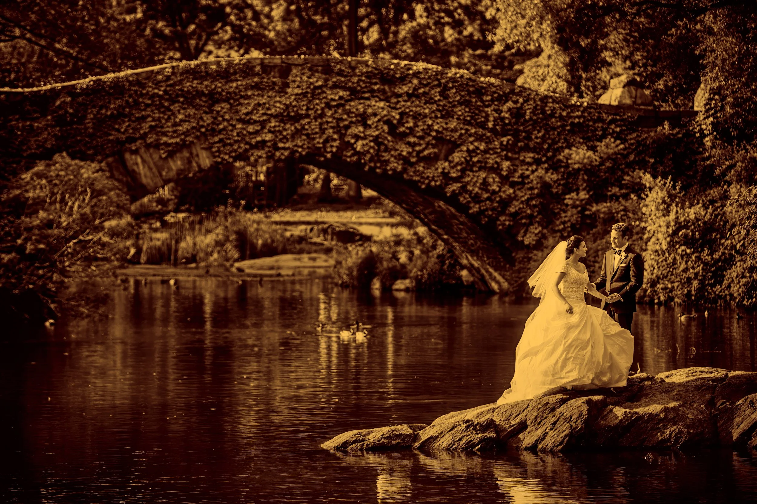 Bride and groom sharing a romantic portrait at The Pond in Central Park near the Metropolitan Club NYC