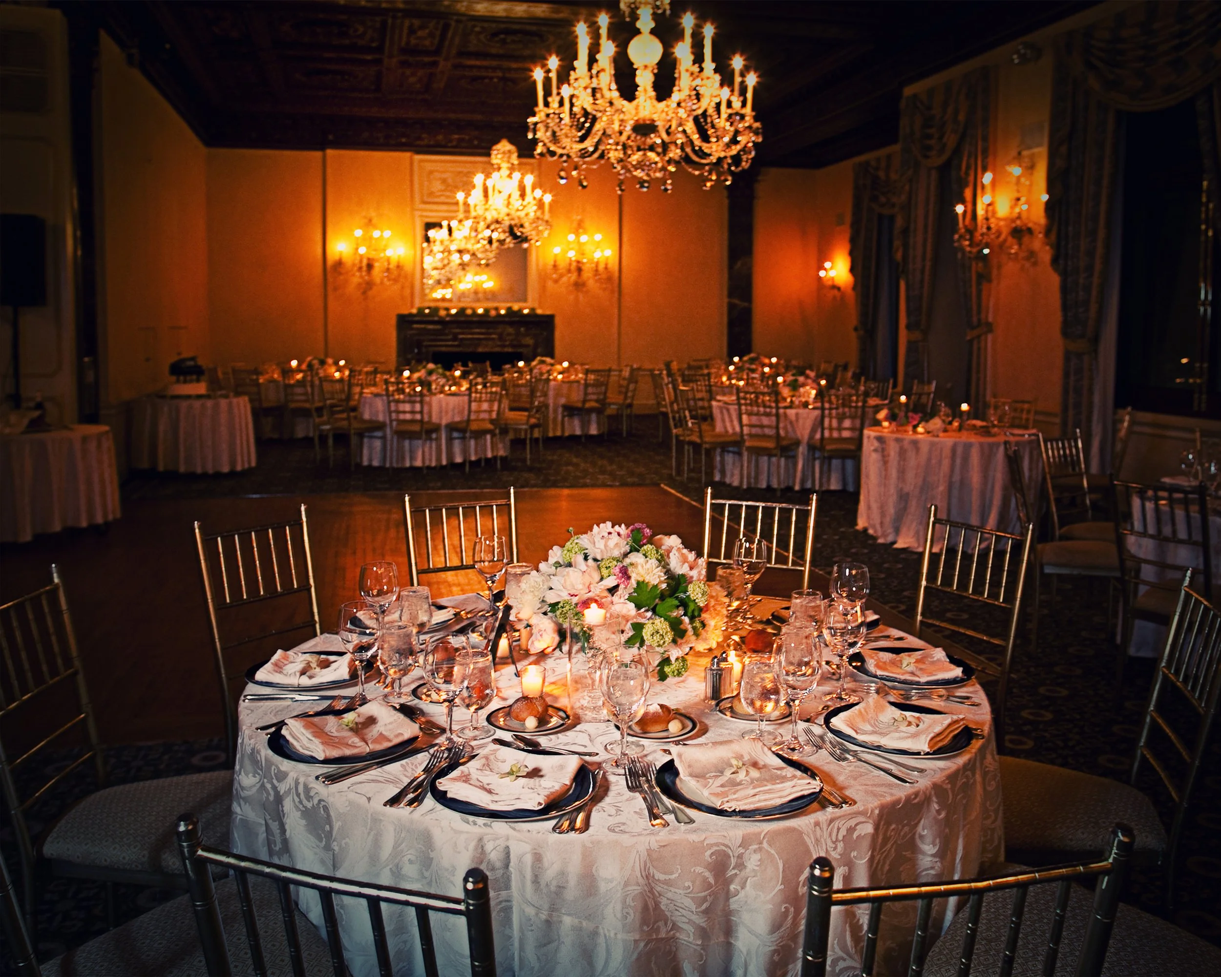 Elegant wedding tablescape set for a reception in the ballroom at the Harmonie Club NYC