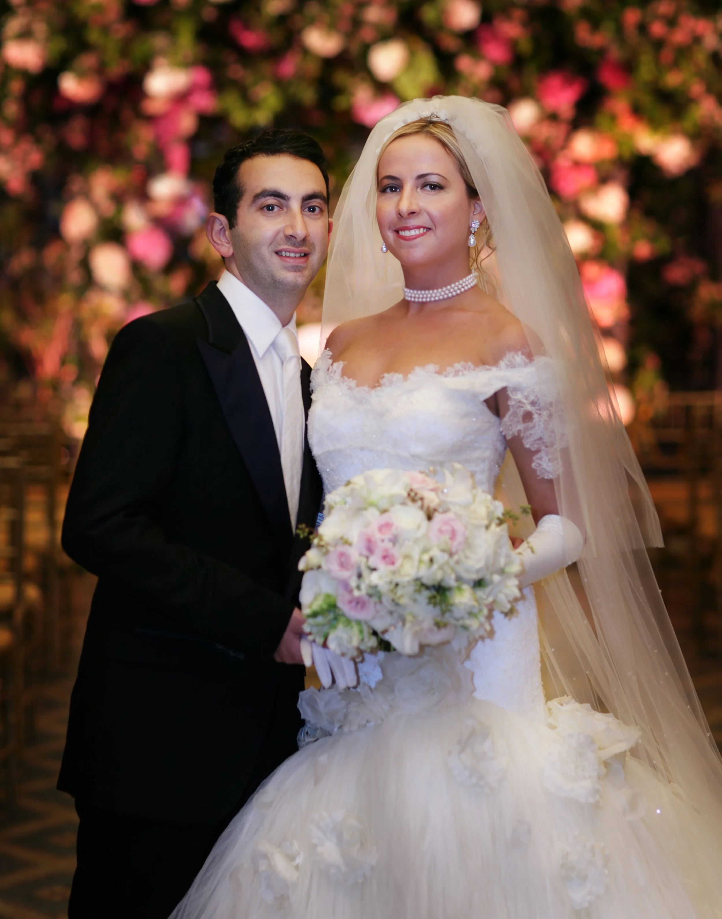 Color Portrait of Bride and Groom with Floral Backdrop at 48 Wall Street NYC