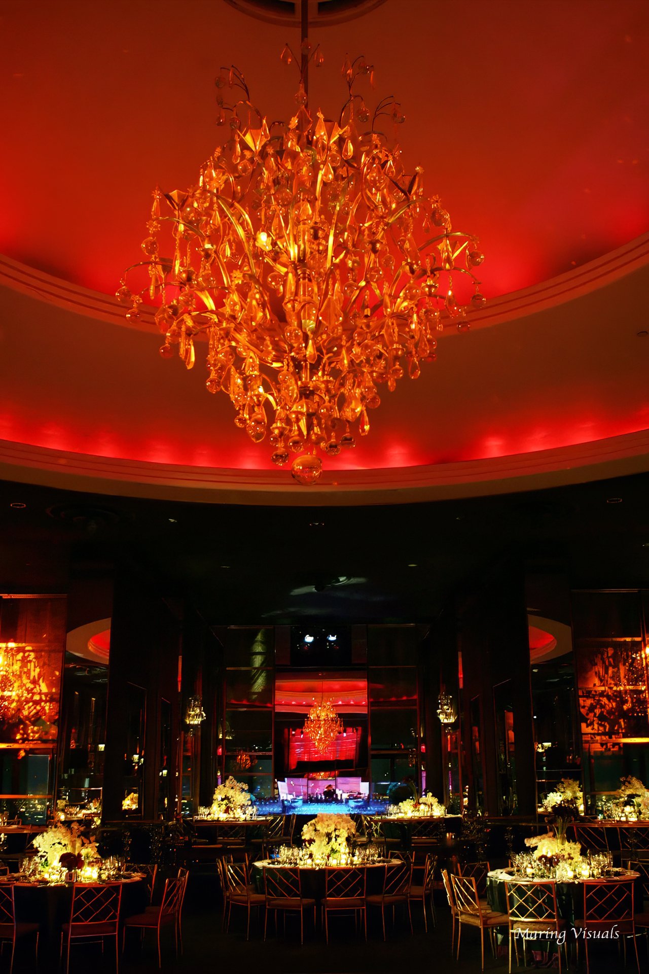 Vertical view of the Rainbow Room NYC chandelier and tables set for a wedding reception.