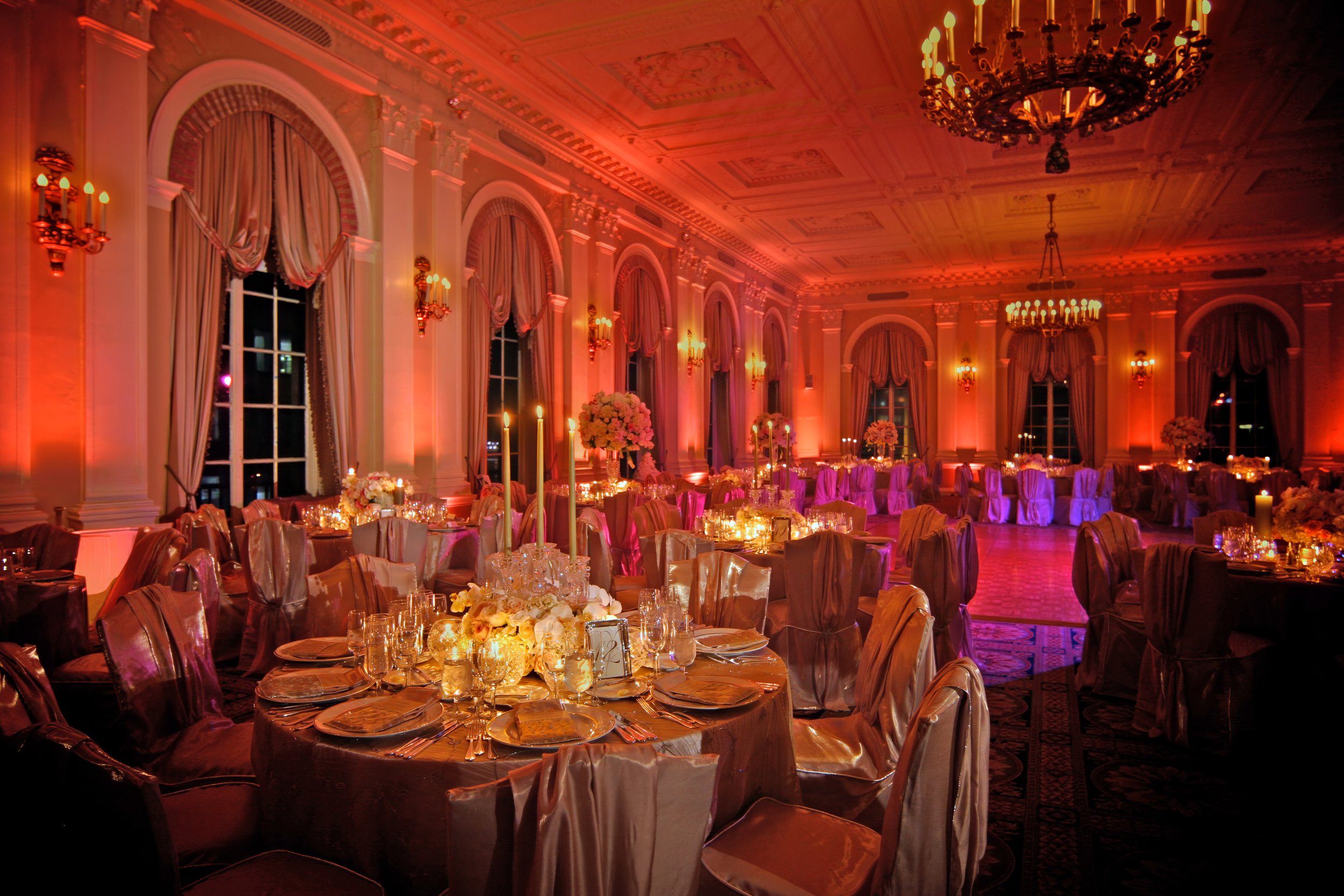 Grand Ballroom sweeping view set for an elegant wedding reception at the Yale Club of New York City with round tables and classic ballroom décor.