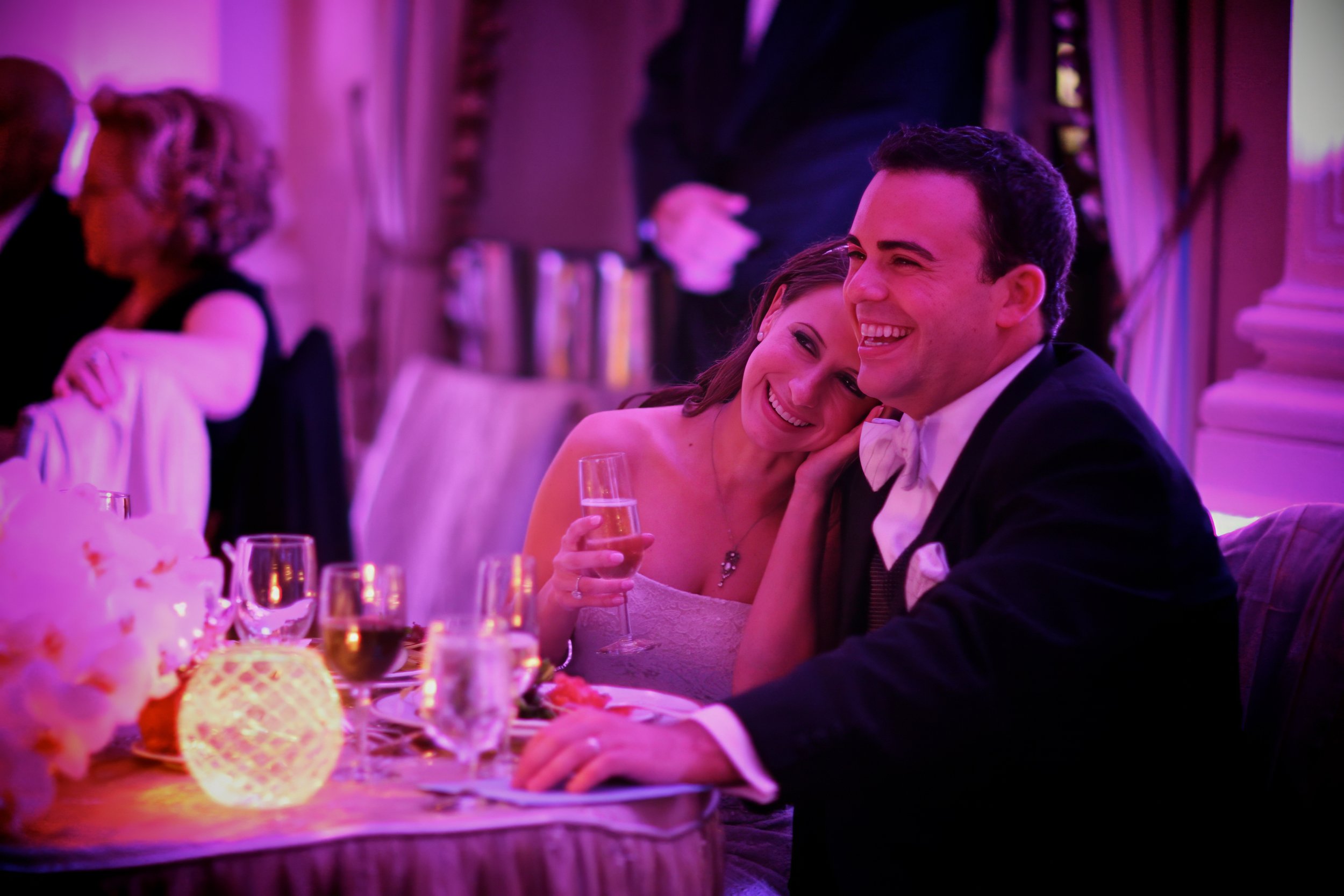 Bride rests her head on the groom’s shoulder while listening to wedding toasts at the Yale Club NYC reception.