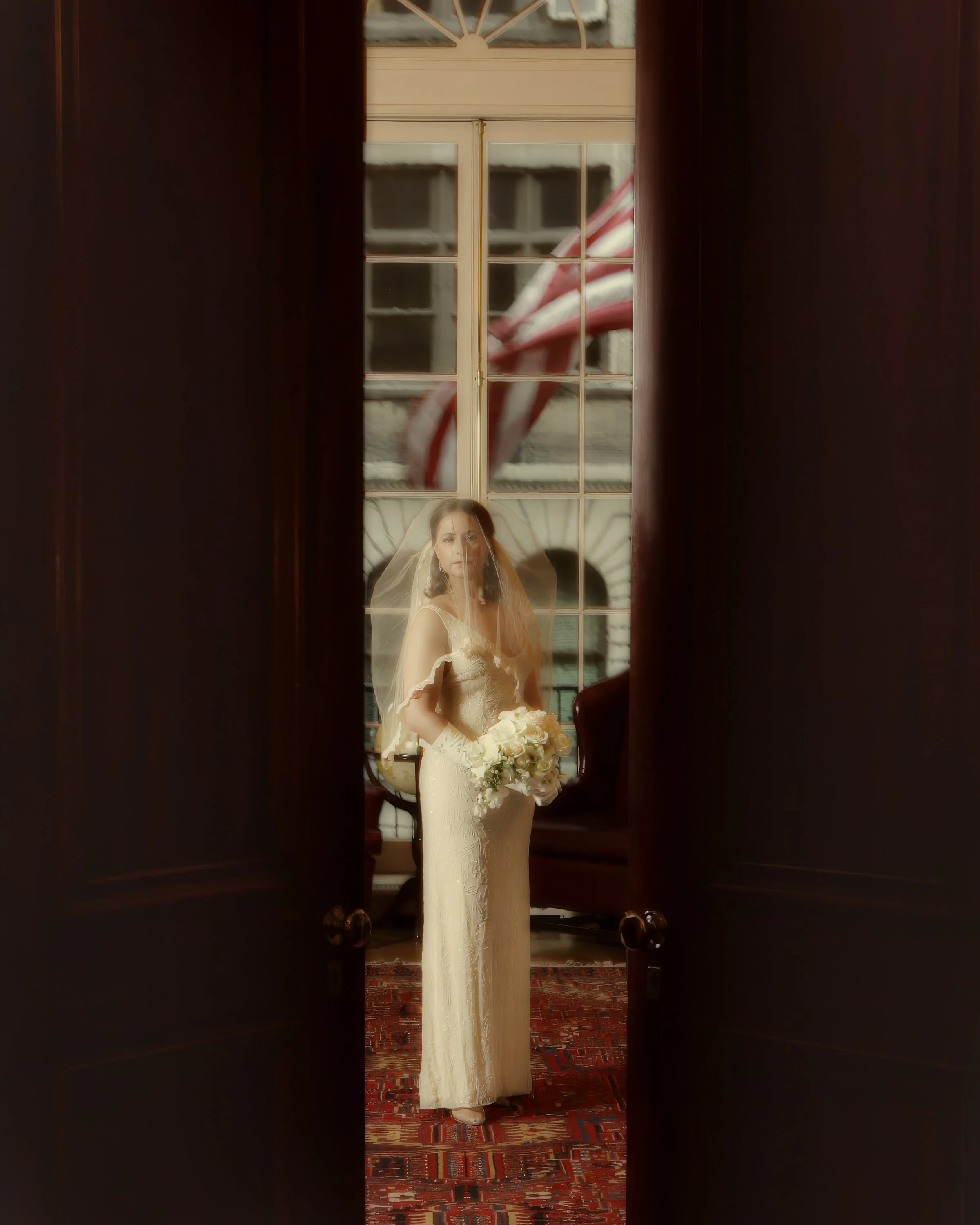 Bridal portrait viewed through the doors of the reading room at the Harvard Club NYC.