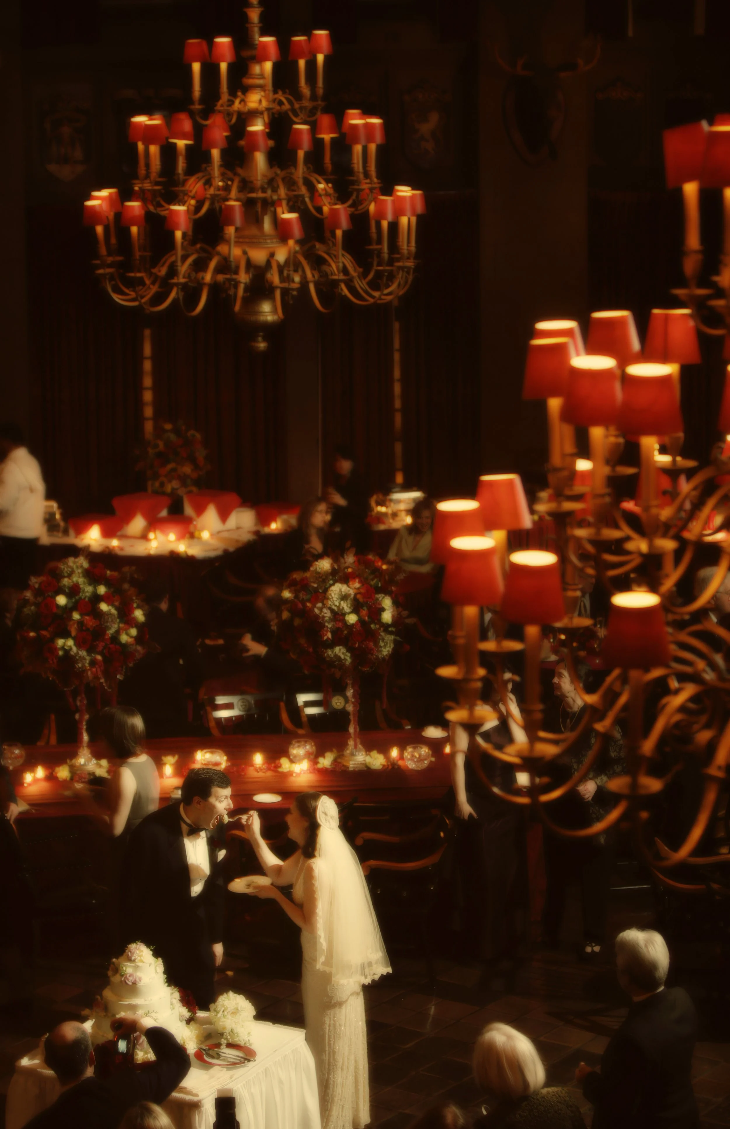 Bride and groom cut their wedding cake in the main dining room at the Harvard Club NYC.