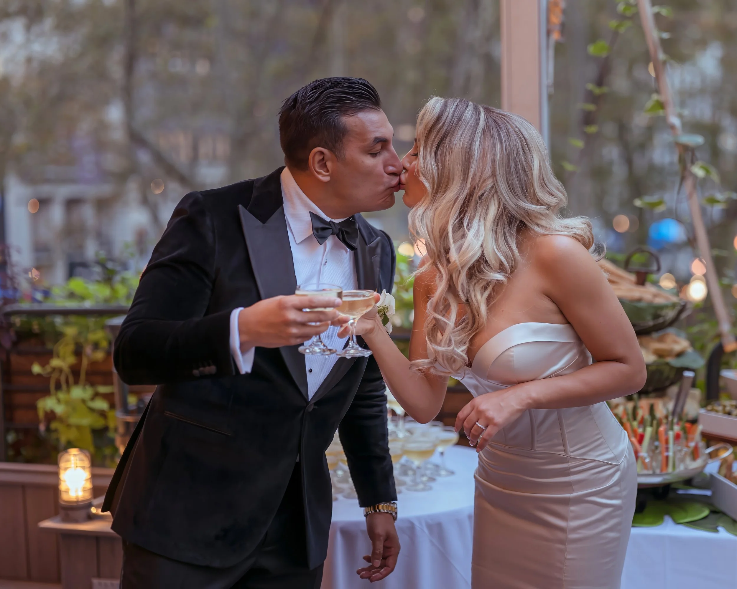 Champagne toast kiss after wedding ceremony on Bryant Park Grill terrace Midtown Manhattan NYC
