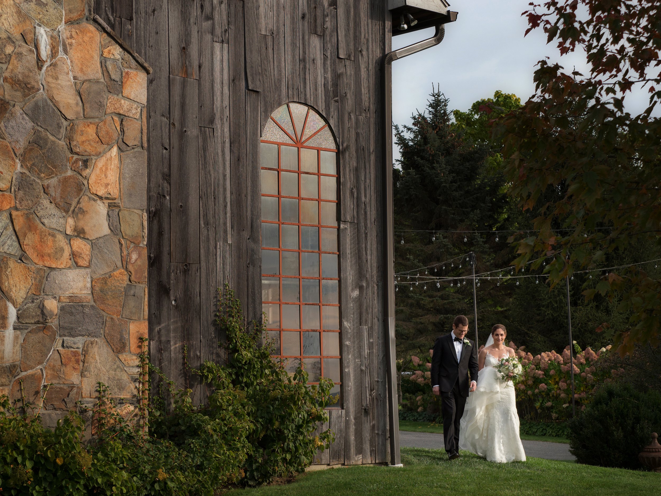 Bride and Groom Walking Near the Barn at Lion Rock Farm