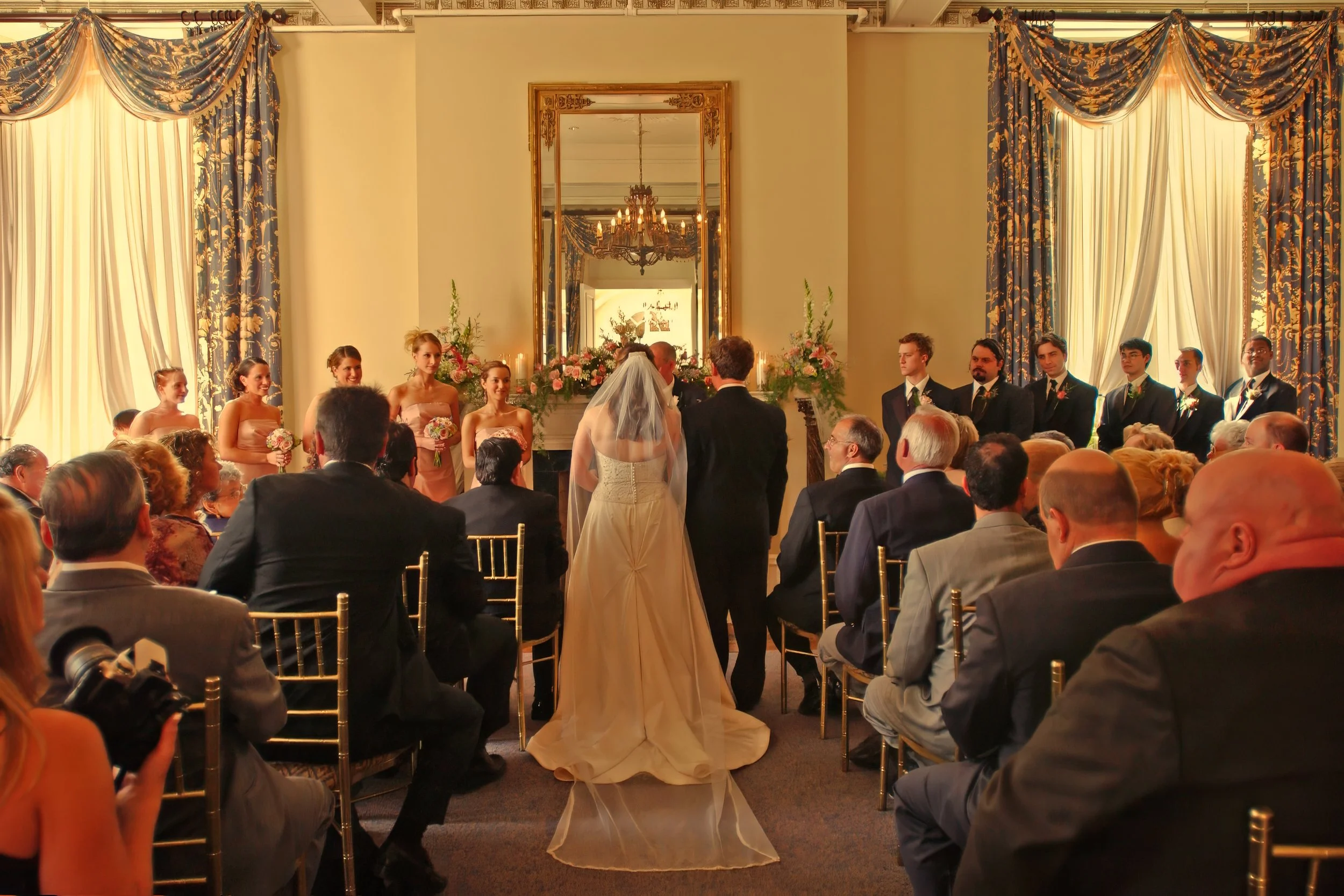 Wide angle wedding ceremony view inside west wing of Wadsworth Mansion with bride and groom at altar