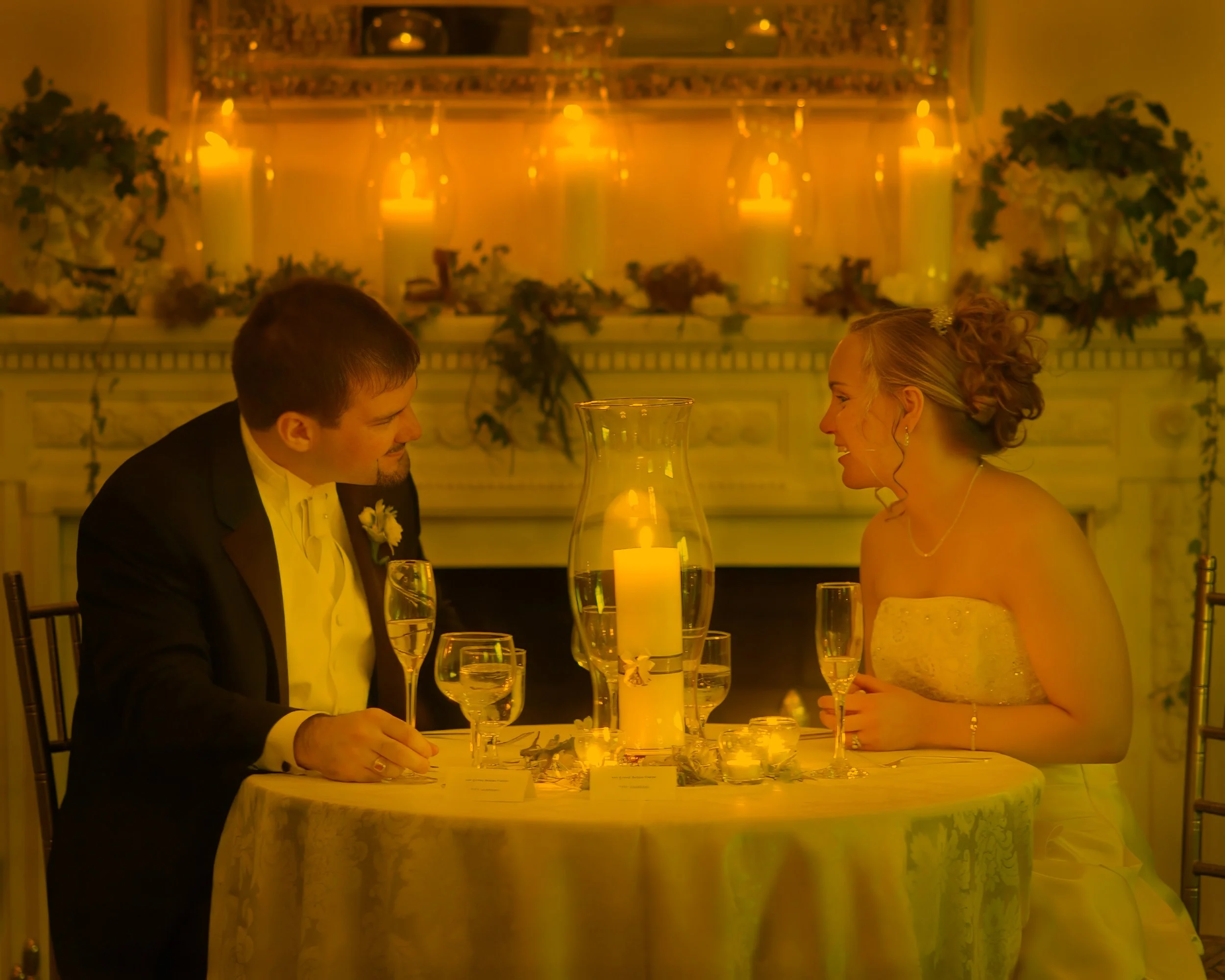 Bride and groom romantic candlelit dinner conversation at Wadsworth Mansion wedding reception
