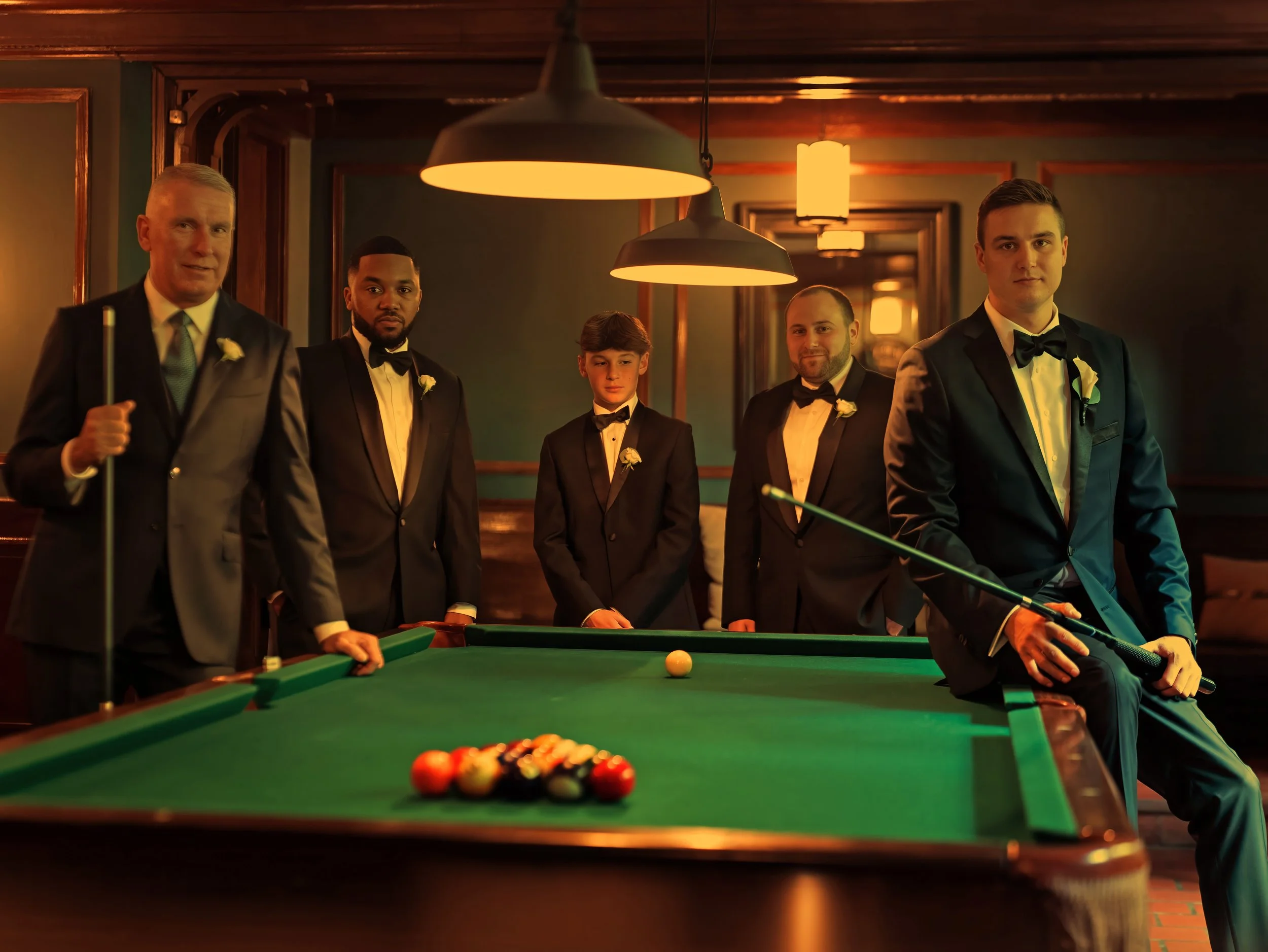 Groomsmen portrait at billiard table inside Lord Thompson Manor wedding venue