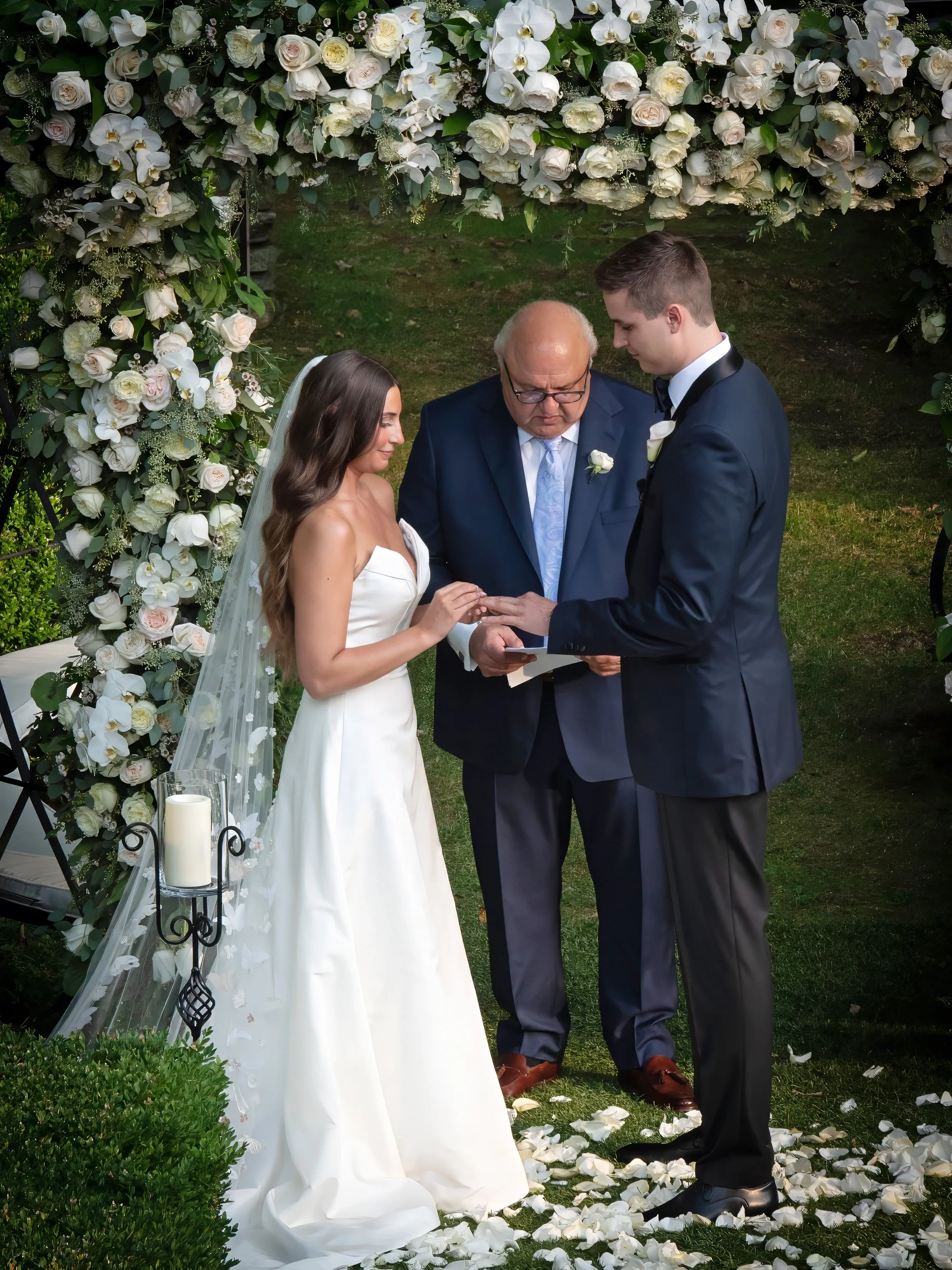 Bride and groom exchanging vows during outdoor side garden ceremony at Lord Thompson Manor wedding