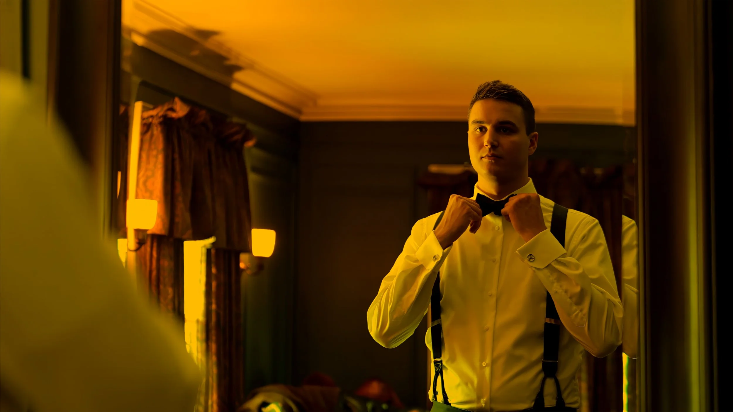 Groom Adjusting Bowtie at Lord Thompson Manor