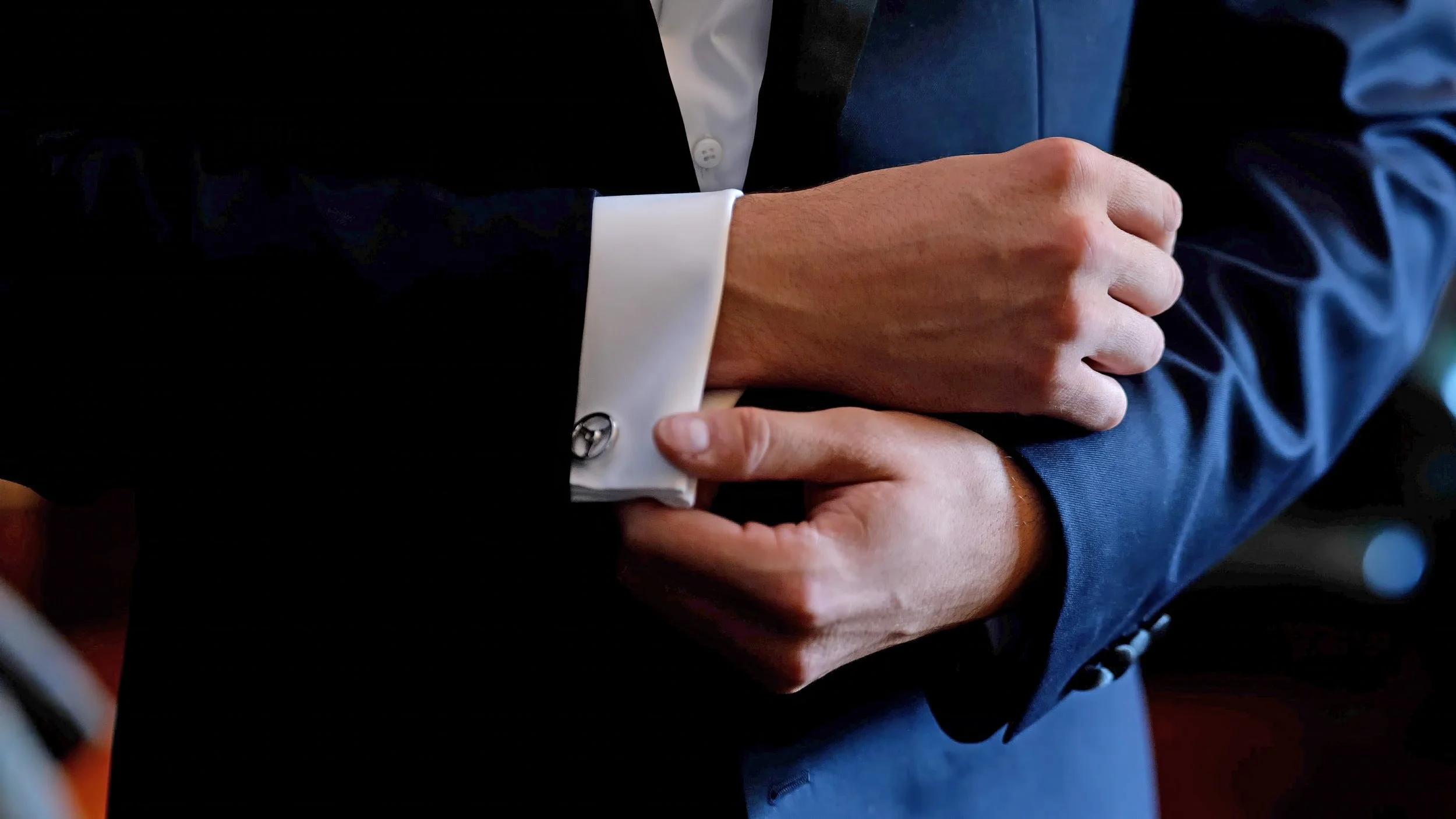 Groom Adjusting Cufflinks at Lord Thompson Manor
