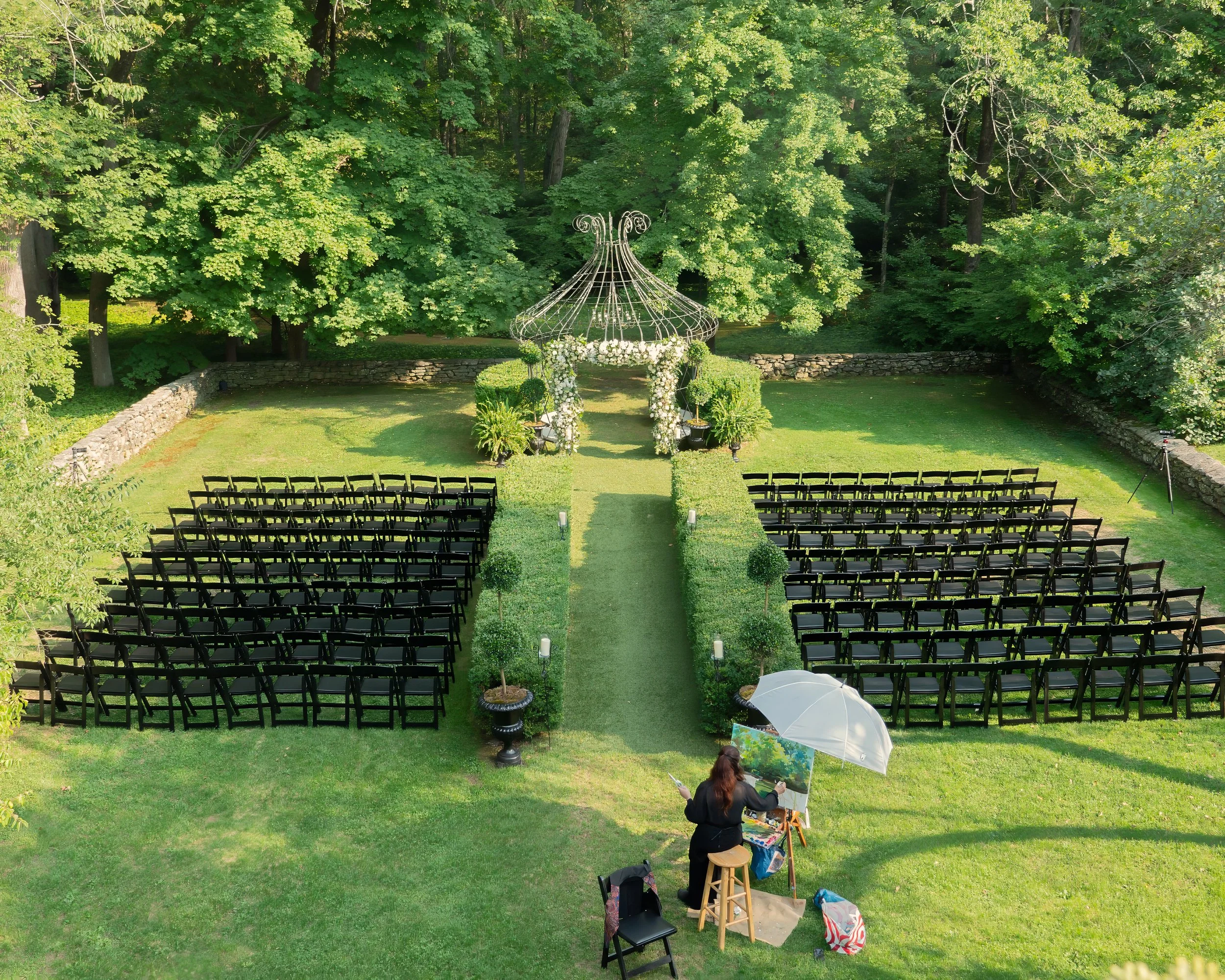 Aerial view of side garden wedding setup at Lord Thompson Manor Connecticut estate venue Caption: