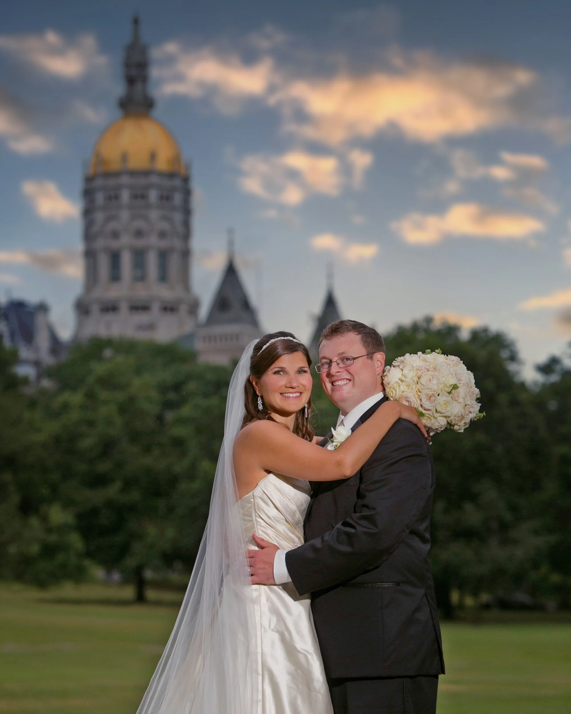 Bride and groom portrait in Bushnell Park with Connecticut State Capitol Hartford