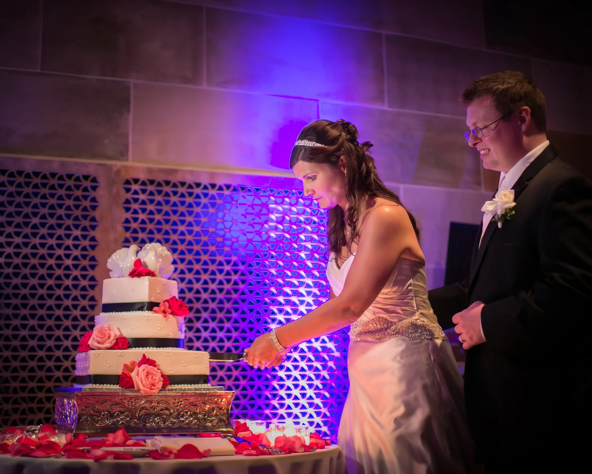 Bride and groom cutting wedding cake at The Society Room of Hartford reception