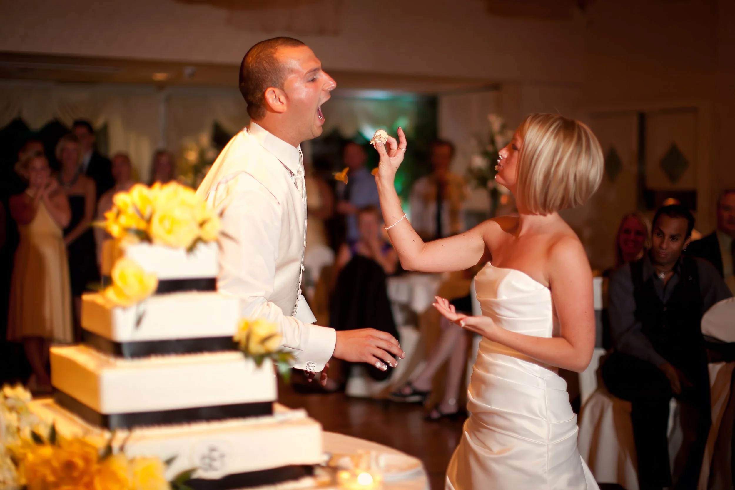Bride Feeds Groom Cake at Amarante’s Sea Cliff Reception