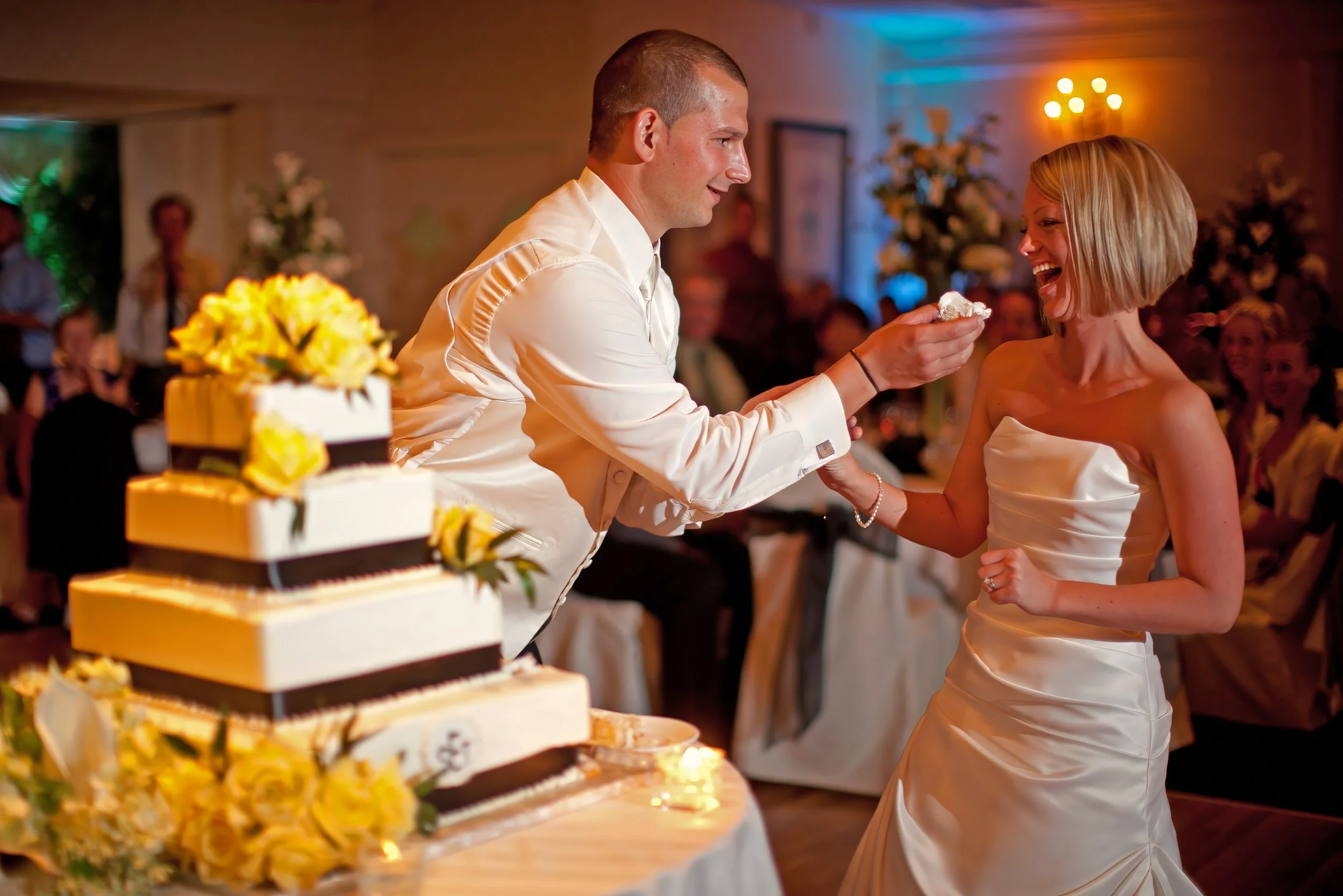 Groom Feeds Bride Cake at Amarante’s Sea Cliff Wedding