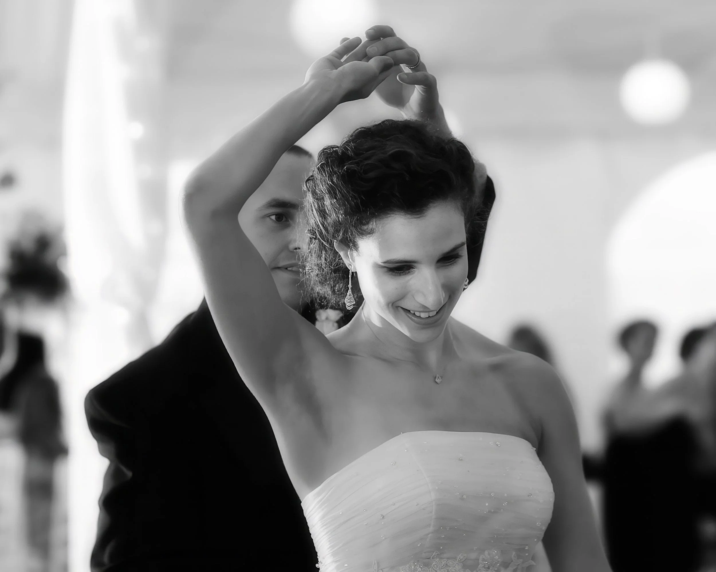 Bride and groom dancing and spinning on reception dance floor at Spa at Norwich Inn wedding celebration in Connecticut