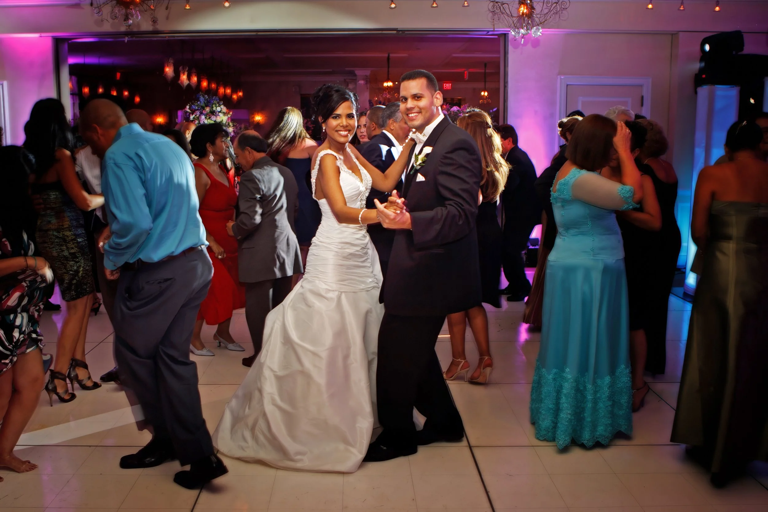 Bride and groom dancing together during a lively wedding reception at Delamar Greenwich Harbor in Greenwich, Connecticut.