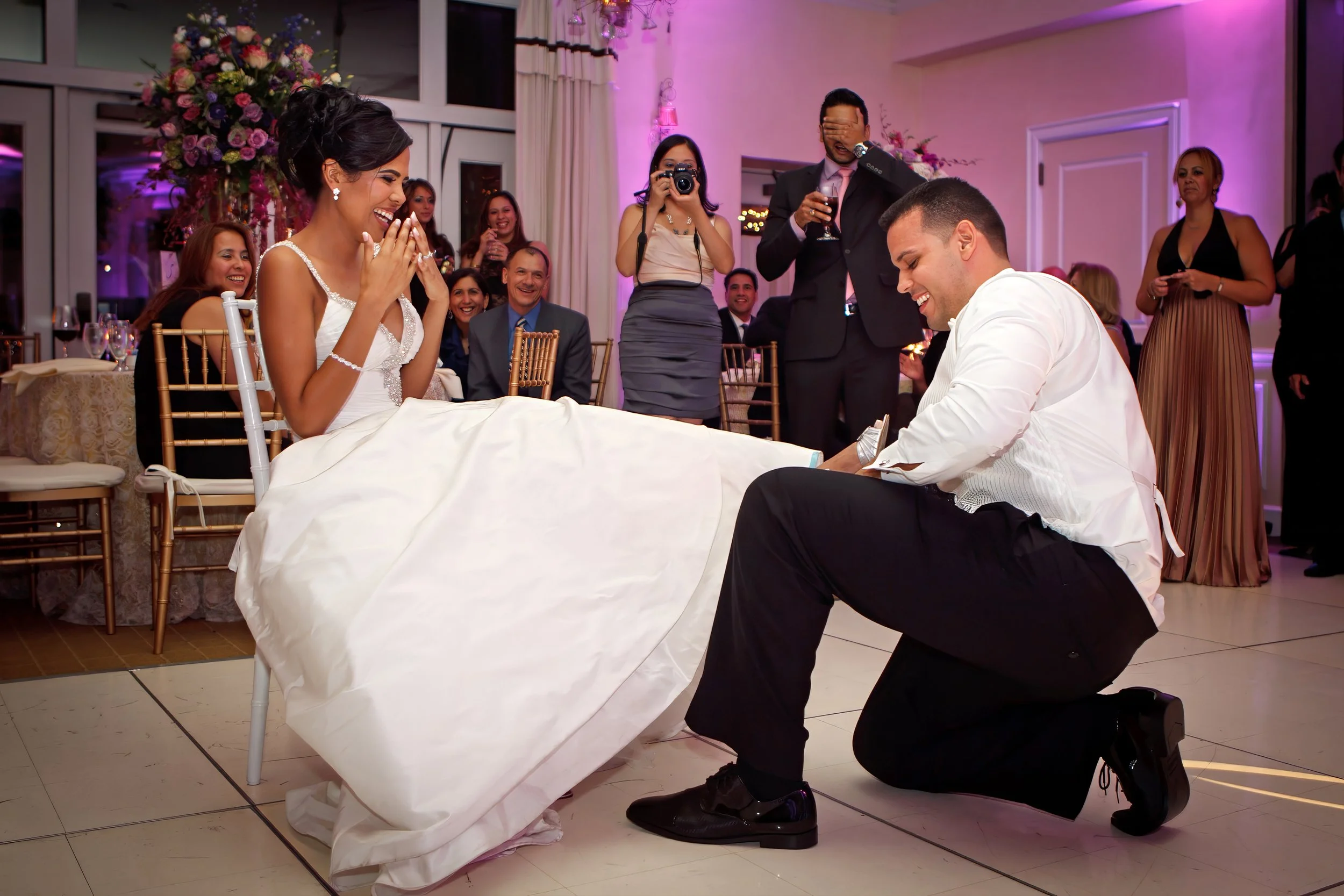 Groom Removes Garter at Delamar Greenwich Harbor