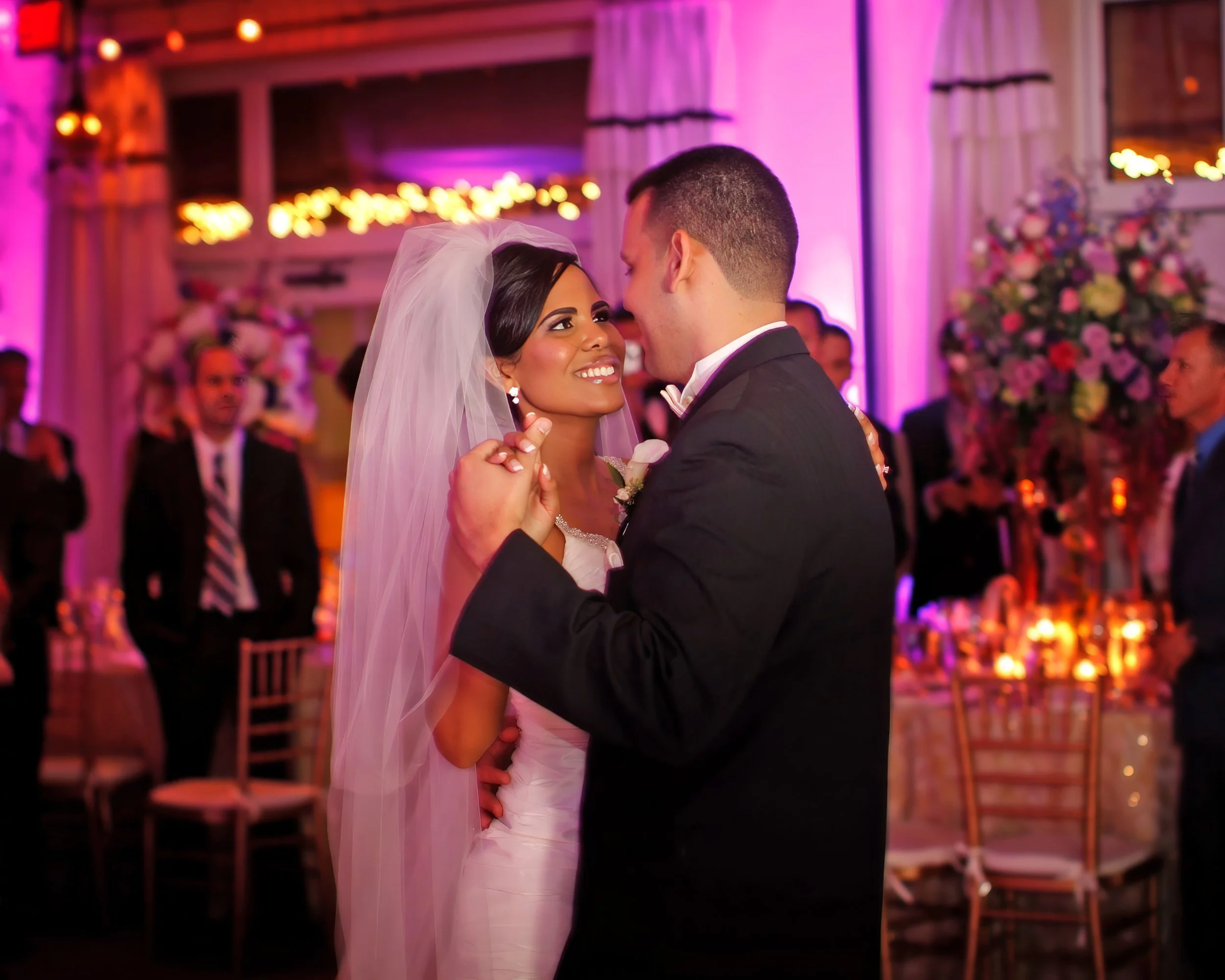 Bride and groom sharing their first dance during an elegant wedding reception at Delamar Greenwich Harbor.