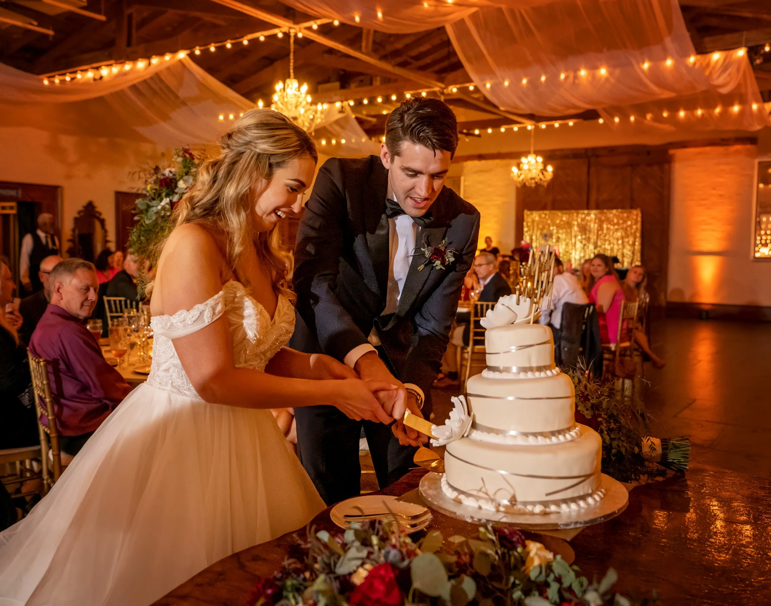 Bride and groom cutting their wedding cake during their Savannah Station wedding reception in Savannah, Georgia.