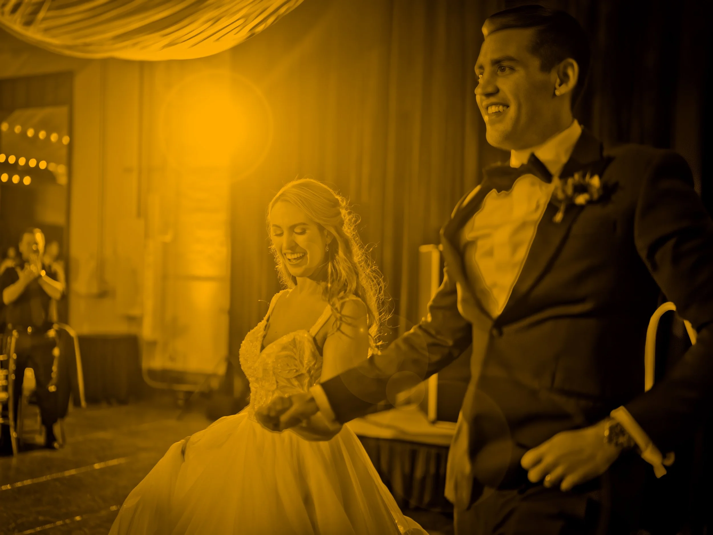 Bride and groom making a joyful grand entrance into their wedding reception at Savannah Station in Savannah, Georgia.