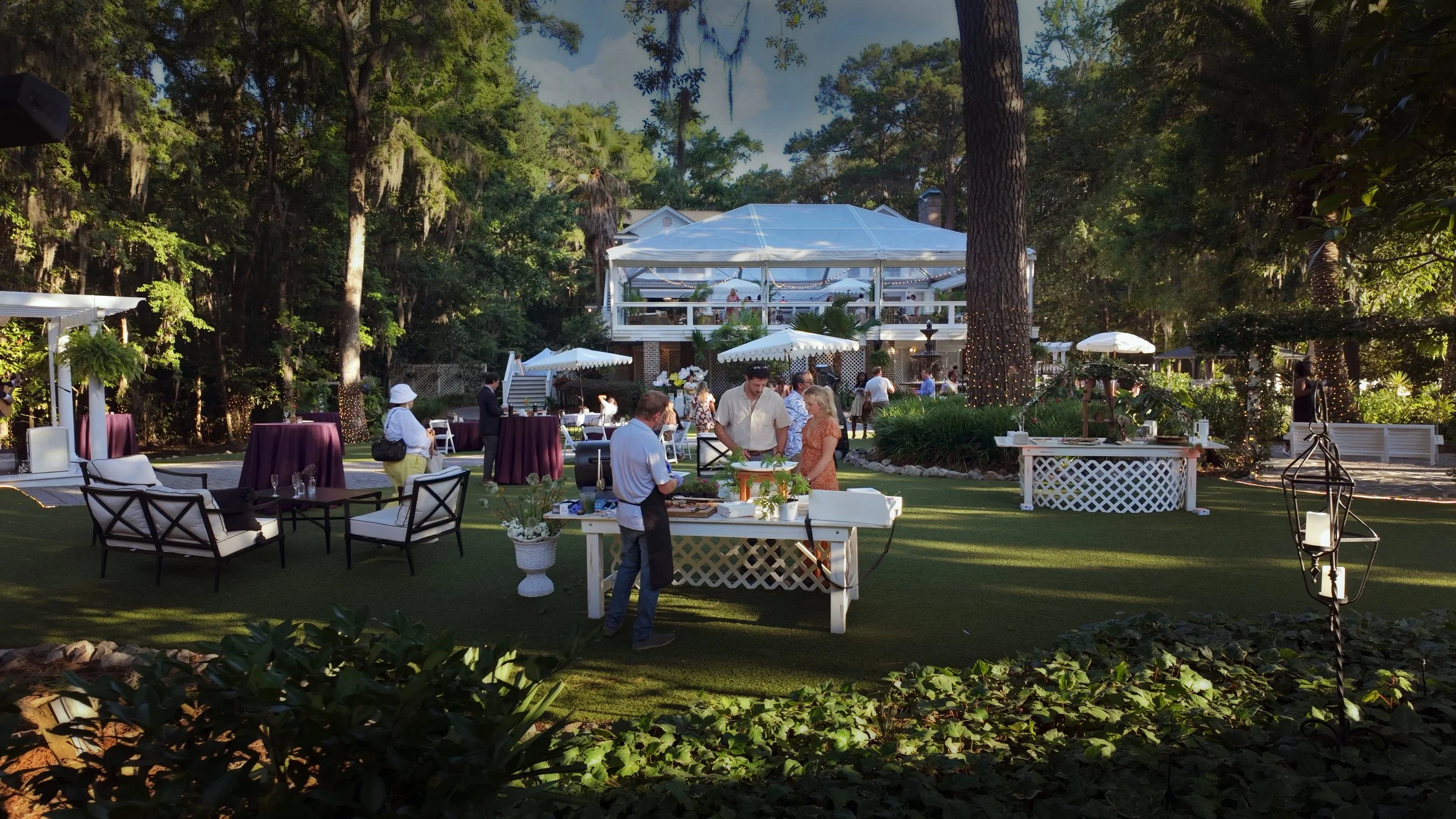 Guests explore entertainment experiences and culinary presentations during a corporate event at The Mackey House in Savannah Georgia.
