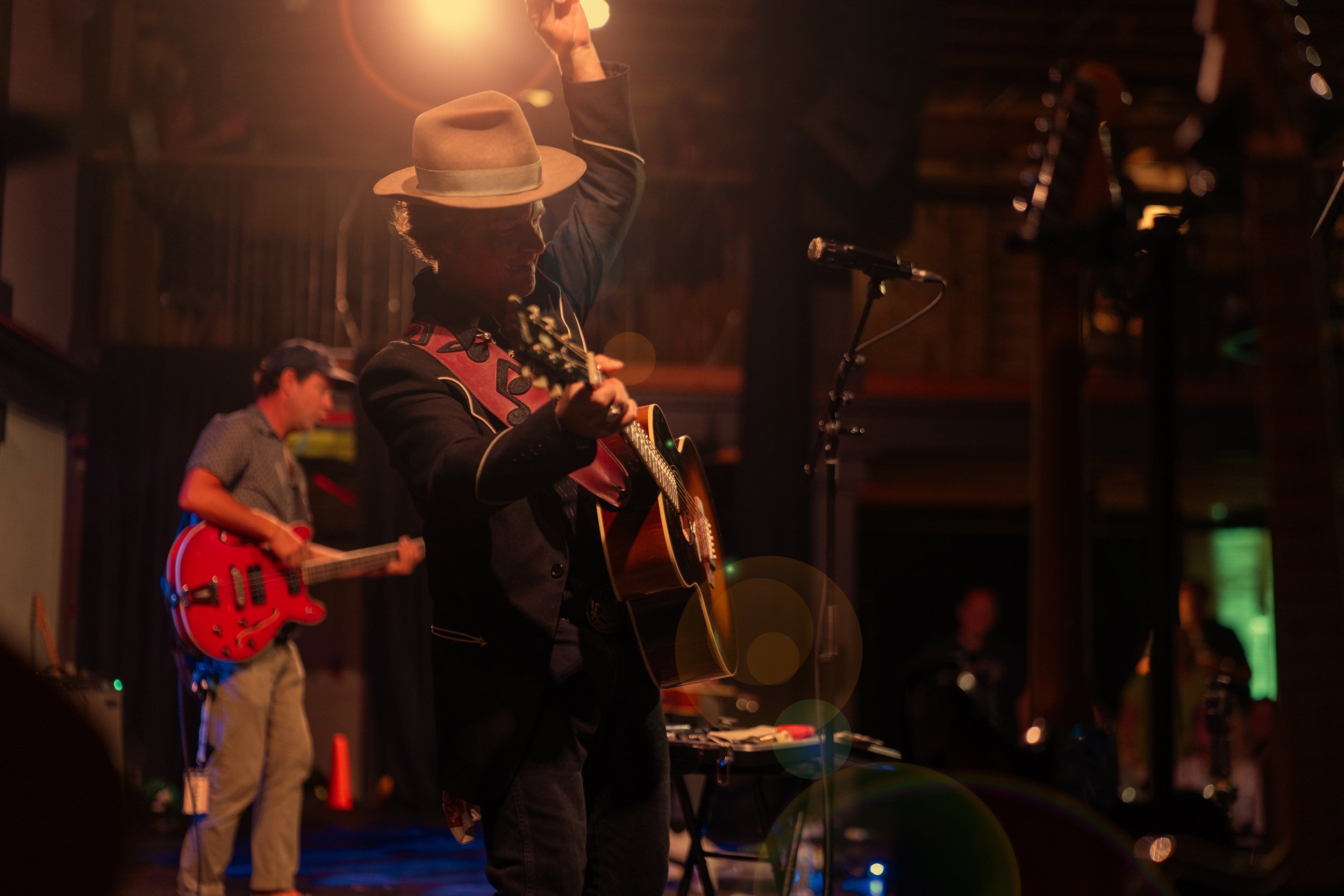 Jason Bible singing and playing guitar alongside bassist Eric Dunn during The Train Wrecks performance at Victory North in Savannah.
