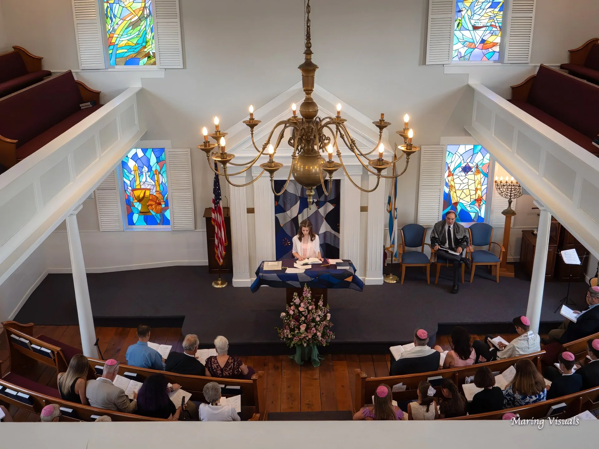 Girl reading from the Torah during her Bat Mitzvah ceremony at a synagogue in Cheshire, Connecticut. Caption:
