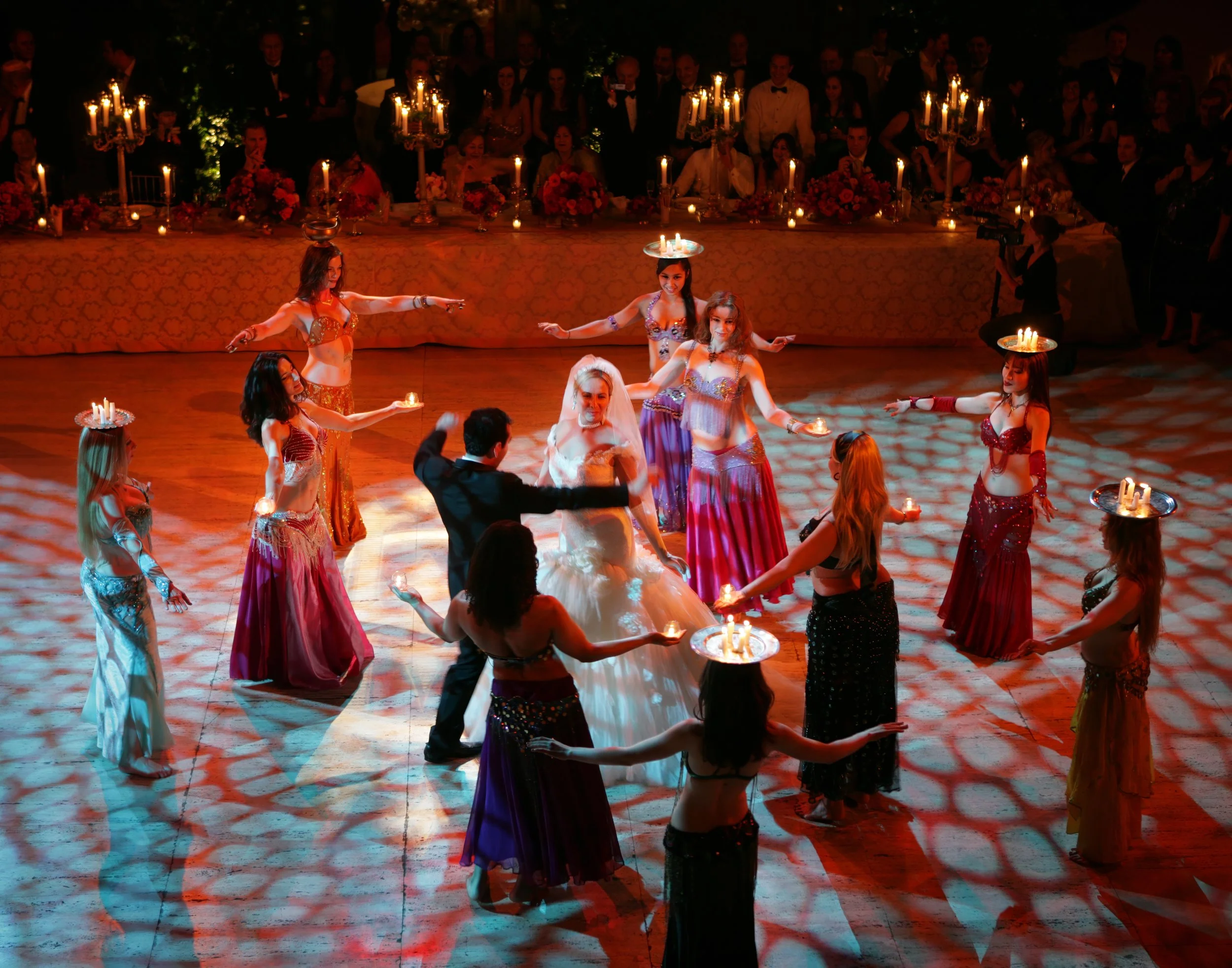 Bride and groom surrounded by belly dancers in the lively ballroom of Cipriani Wall Street.